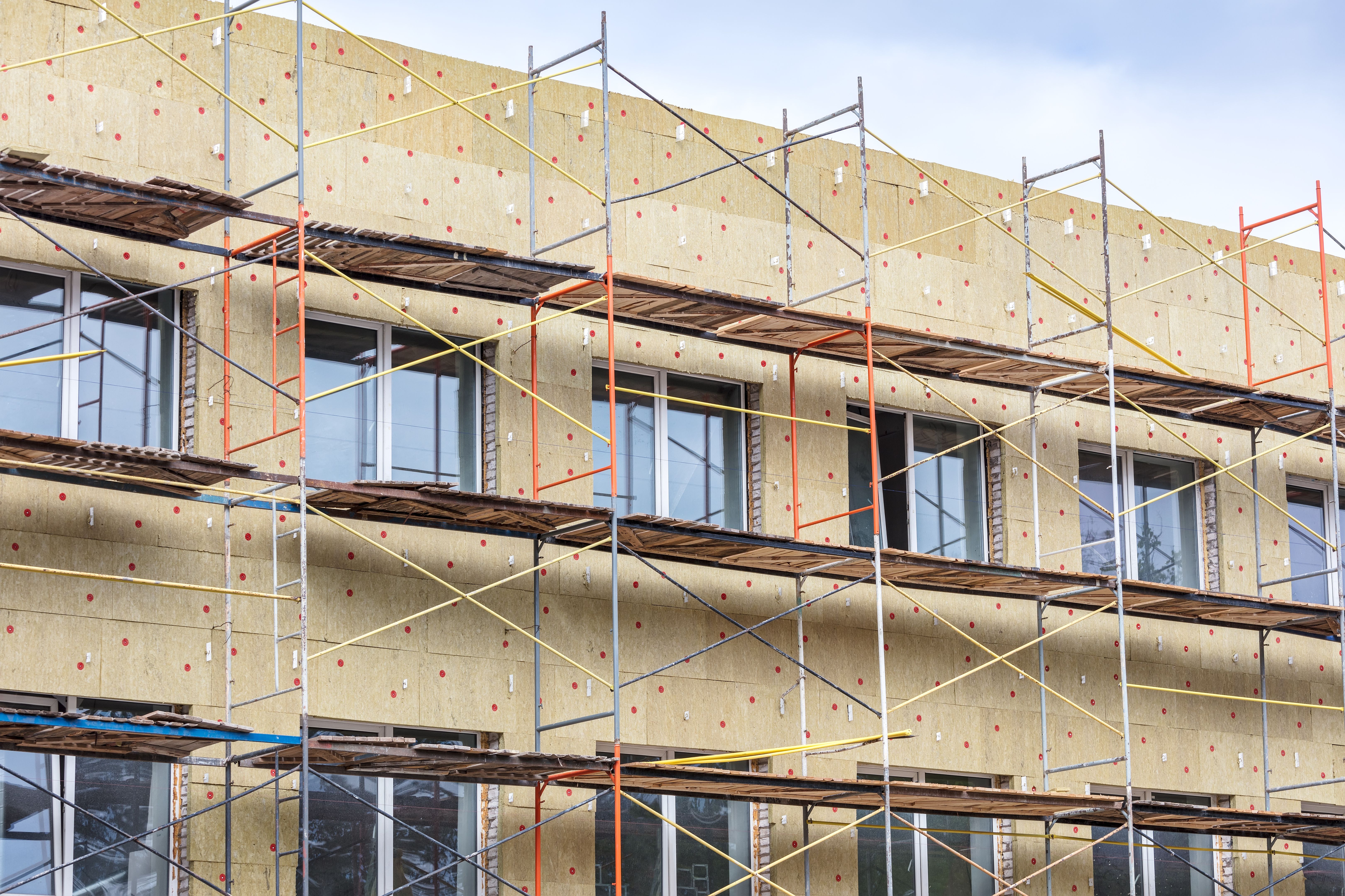 building facade under renovation with scaffolding building facade under renovation with scaffolding