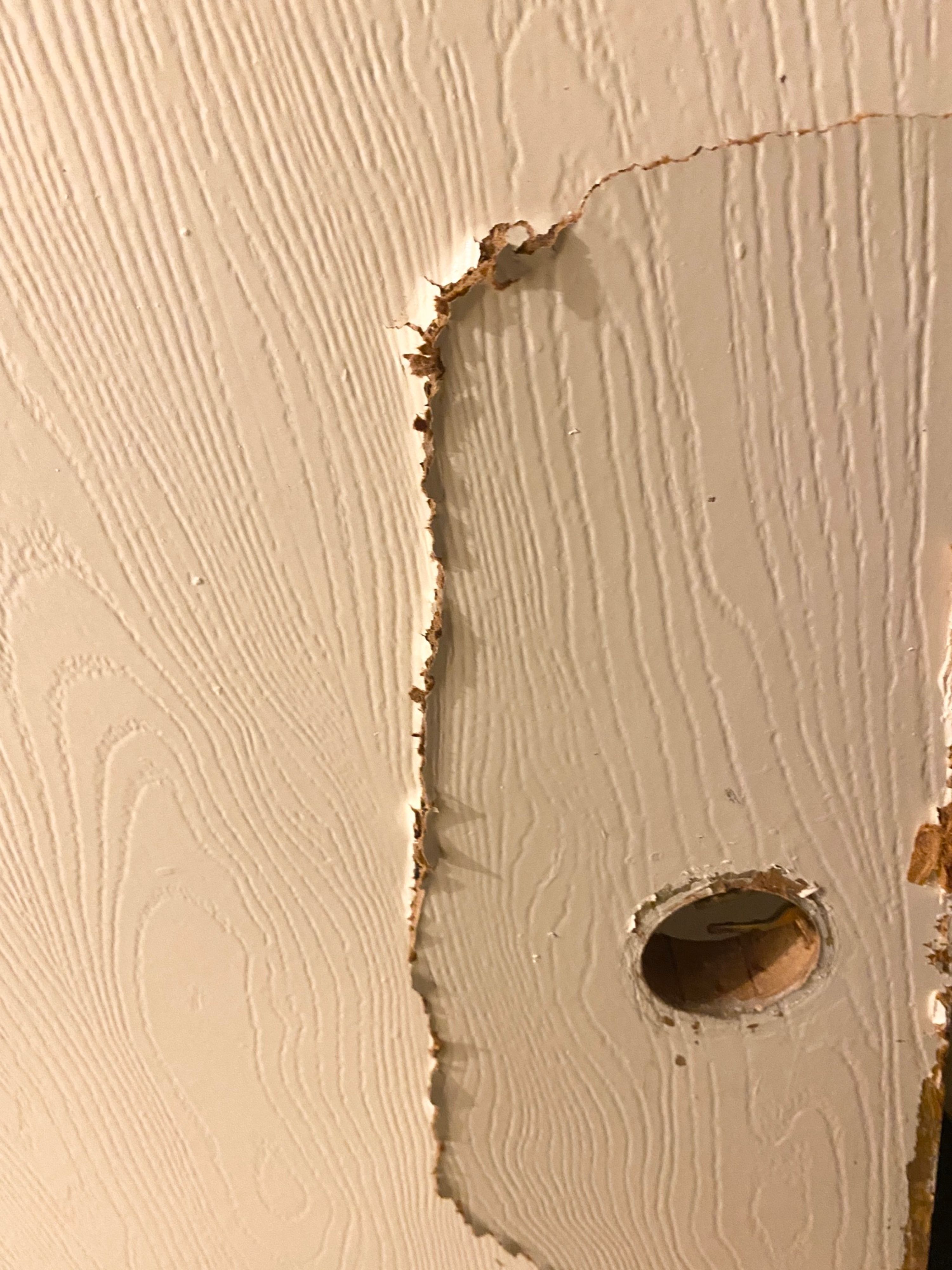 Broken bathroom door that was smashed open after it got stuck