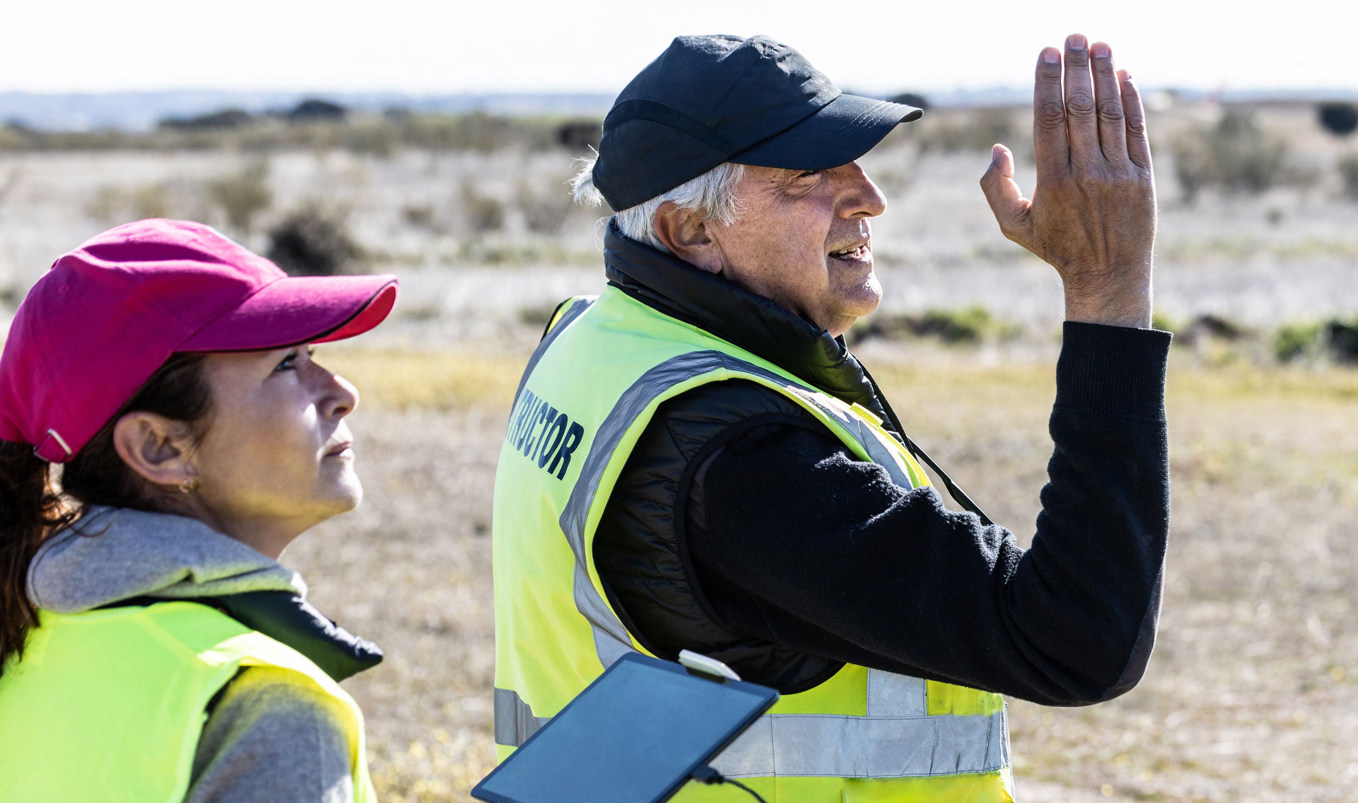 Drone instructor giving directions to his student that he is flying drone