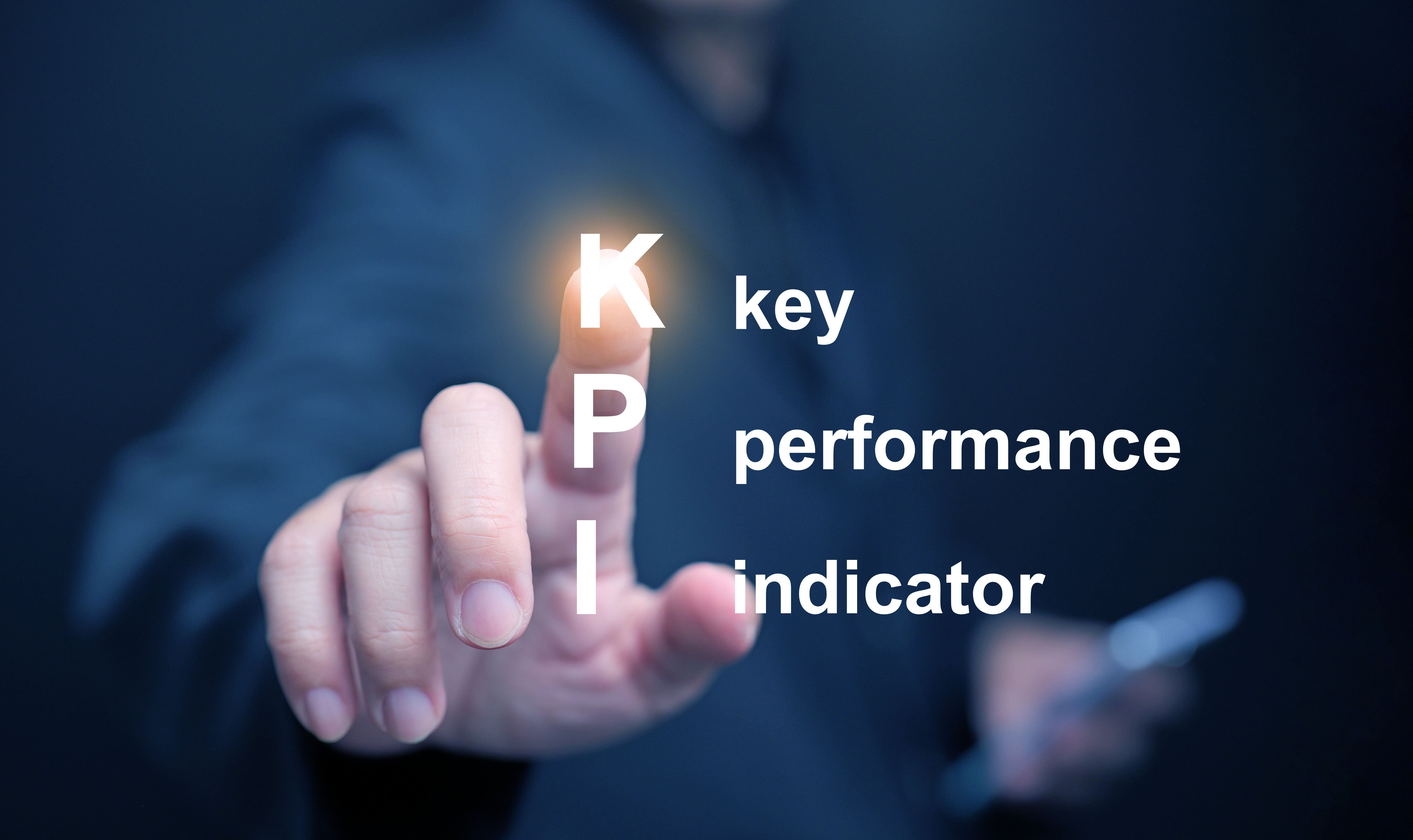 KPI key performance indicator. A businessman tapping on virtual screen to use KPIs to measure progress of his business, project, or work over time to reach the goals