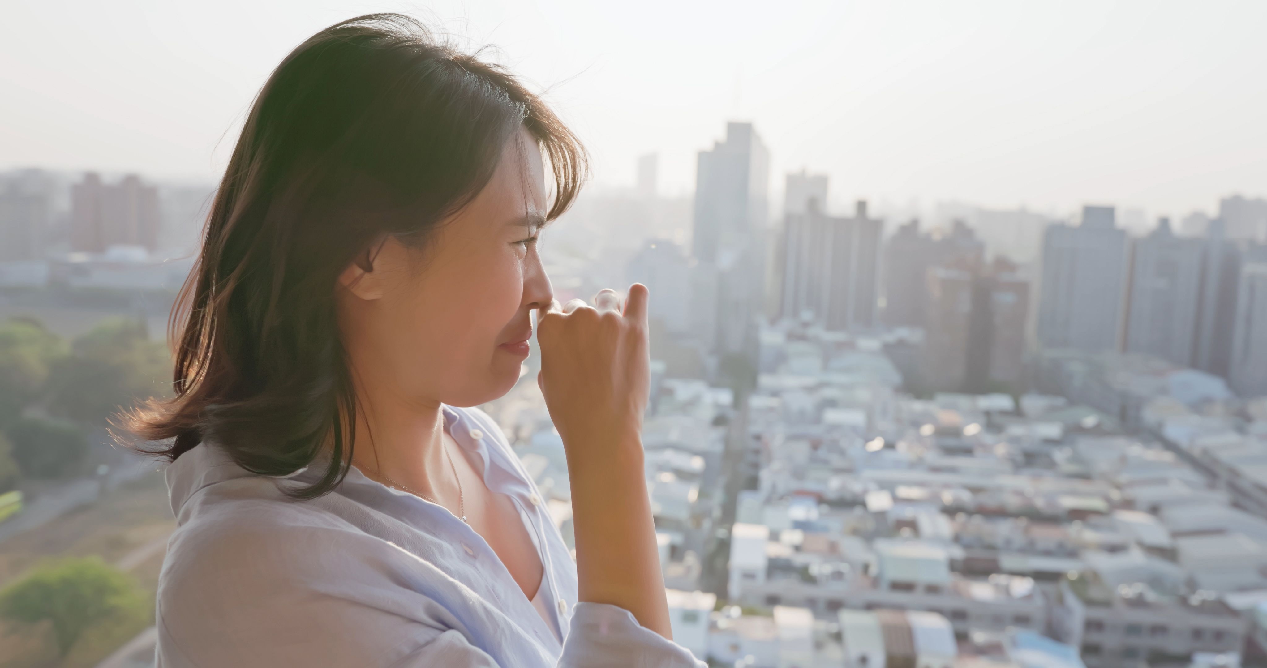 woman cover nose against smell woman cover nose against smell