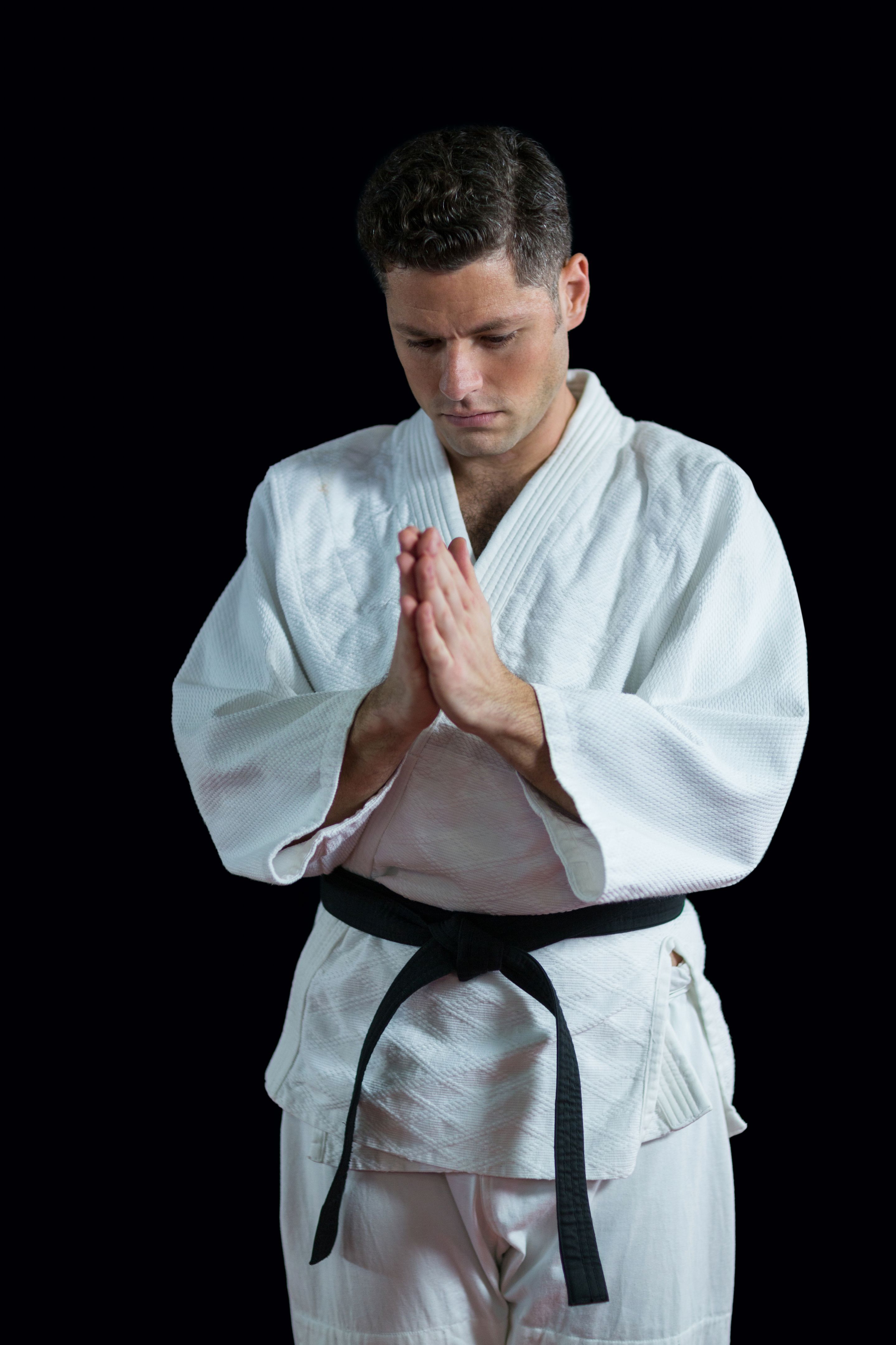 Karate player in prayer pose