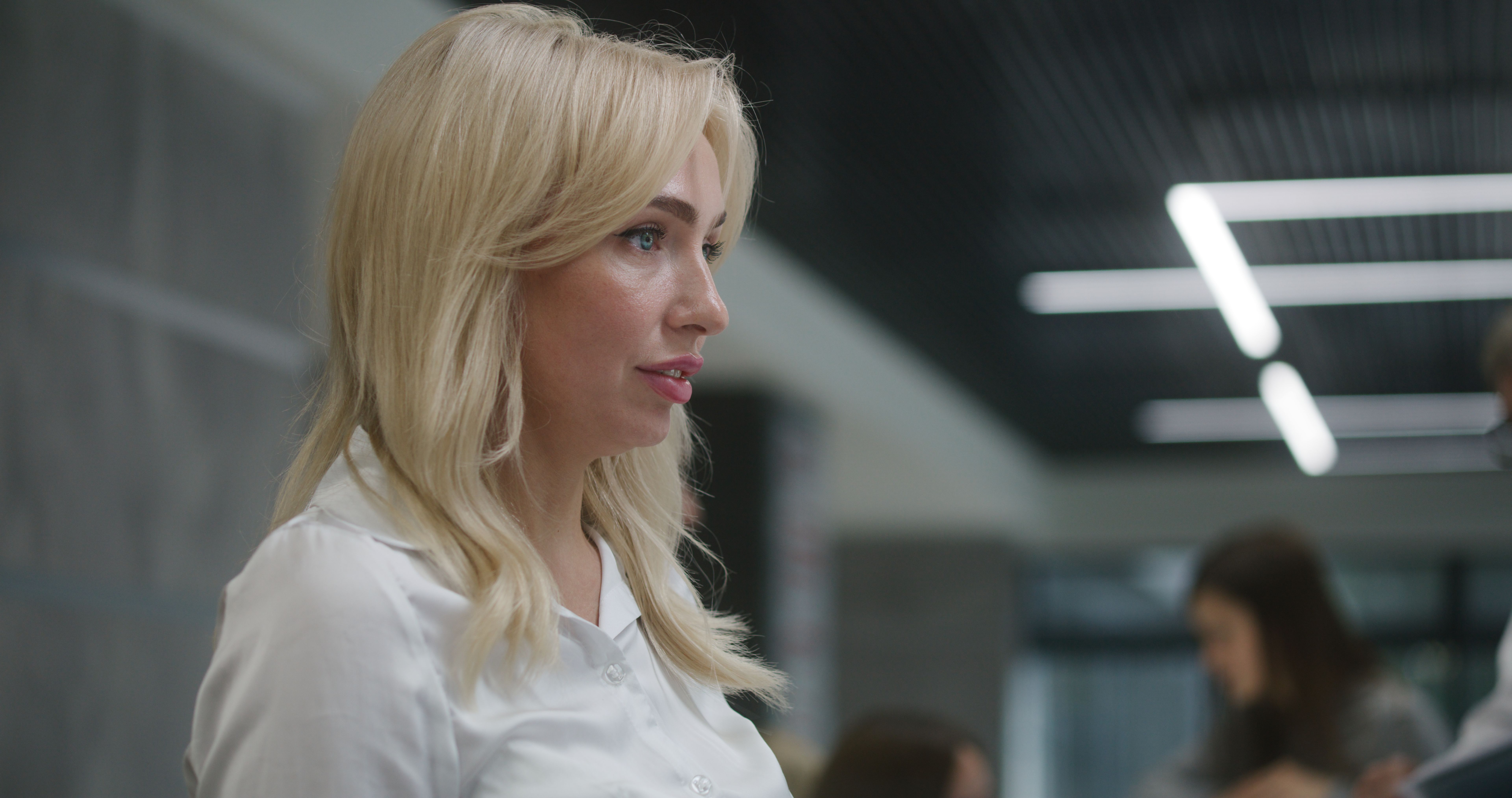 Female receptionist talks with patient at reception desk in clinic Female receptionist talks with patient at reception desk in clinic