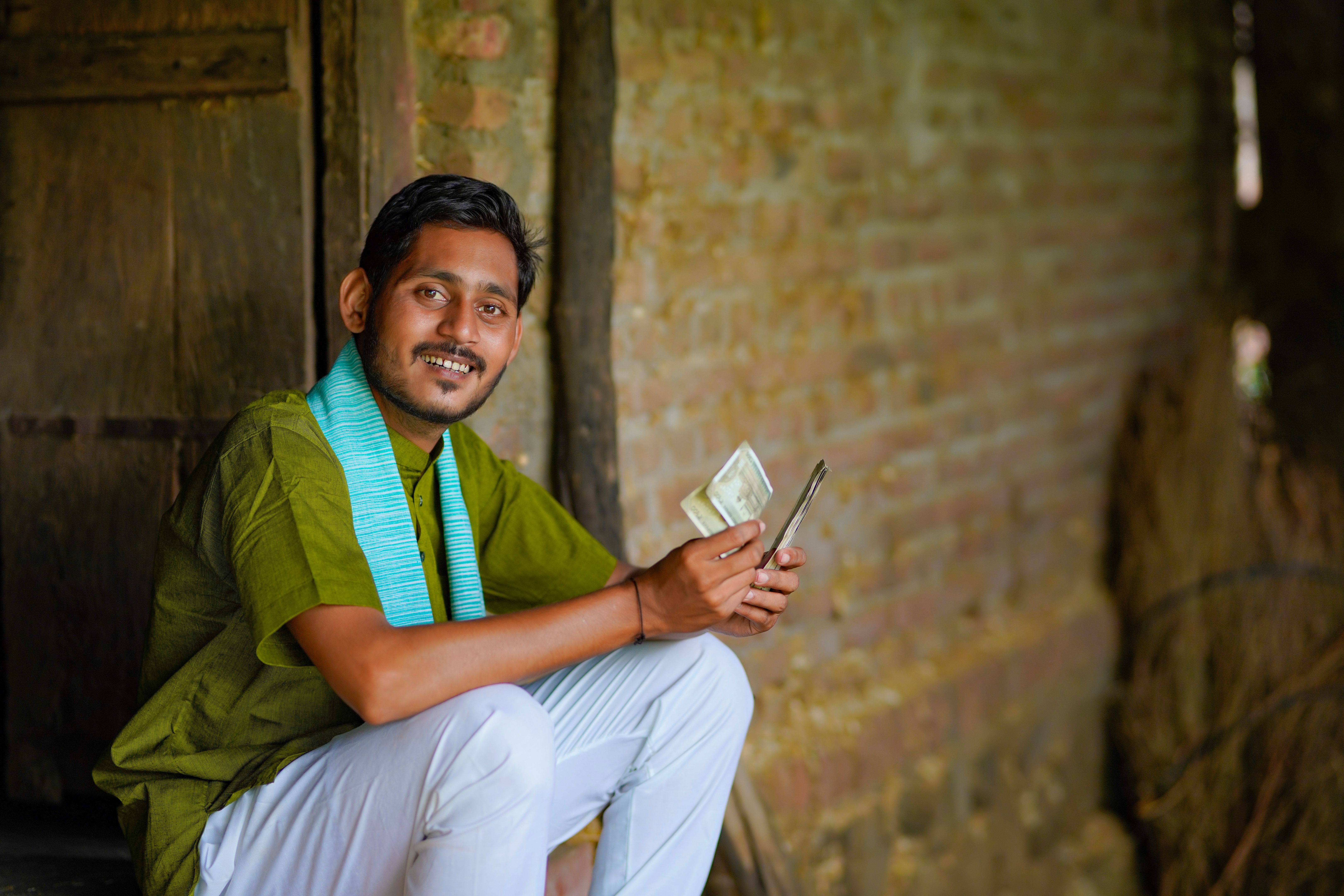 Indian farmer or labor counting money at home. Indian farmer or labor counting money at home.