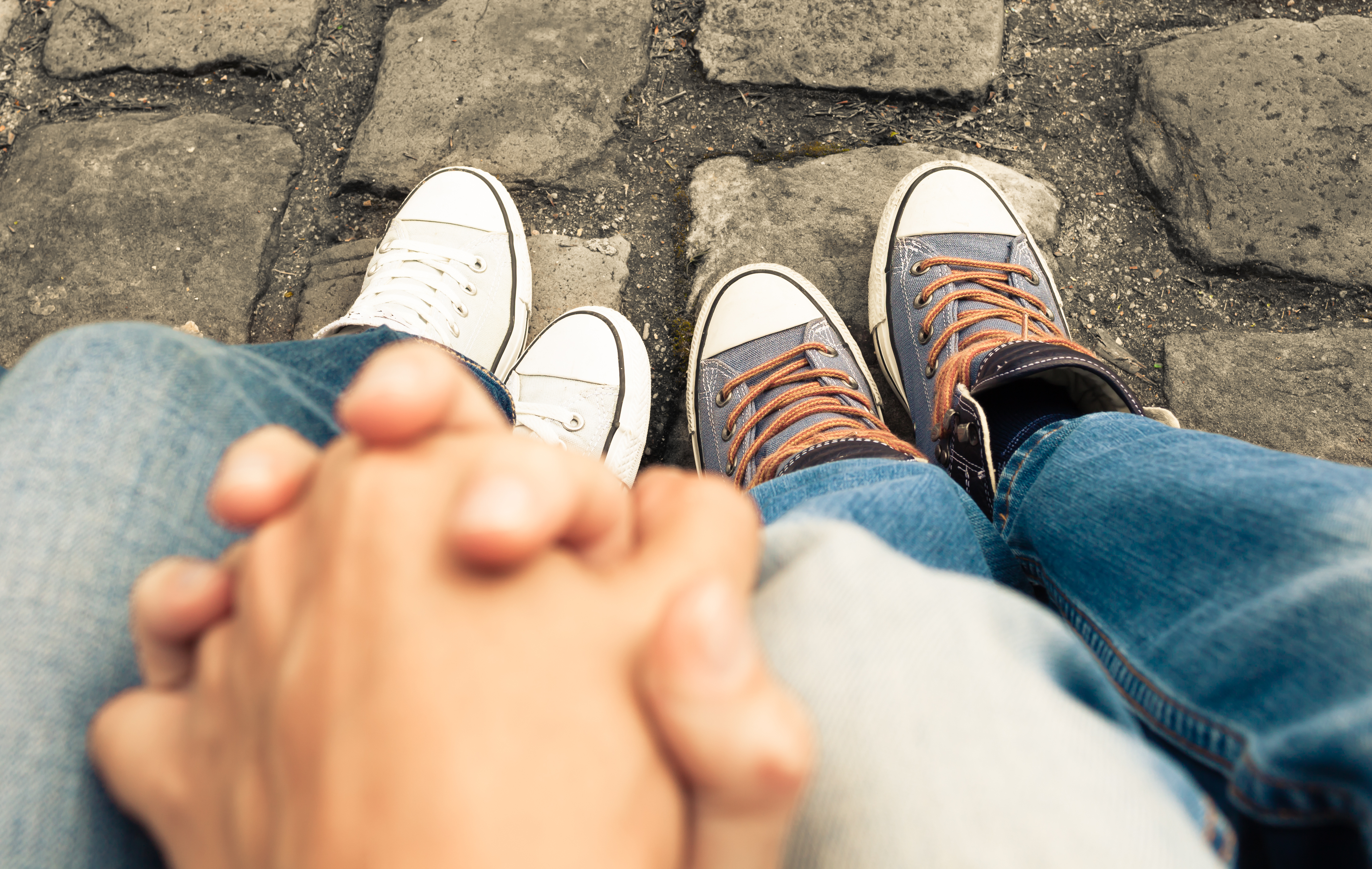 Couple sitting on a bench holding hands Couple sitting on a bench holding hands