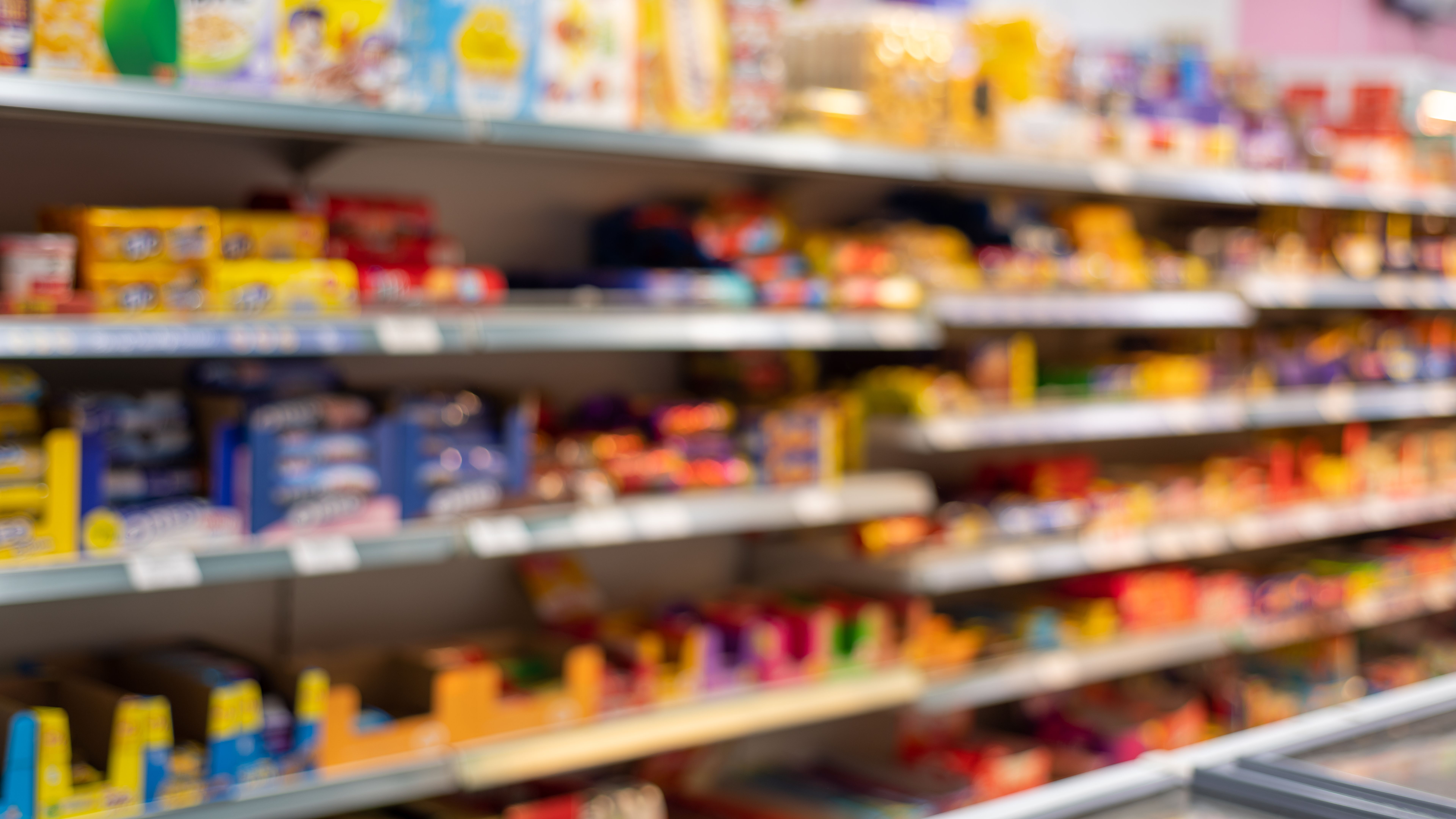 Defocused food store shelf with pre-packaged food Defocused food store shelf with pre-packaged food
