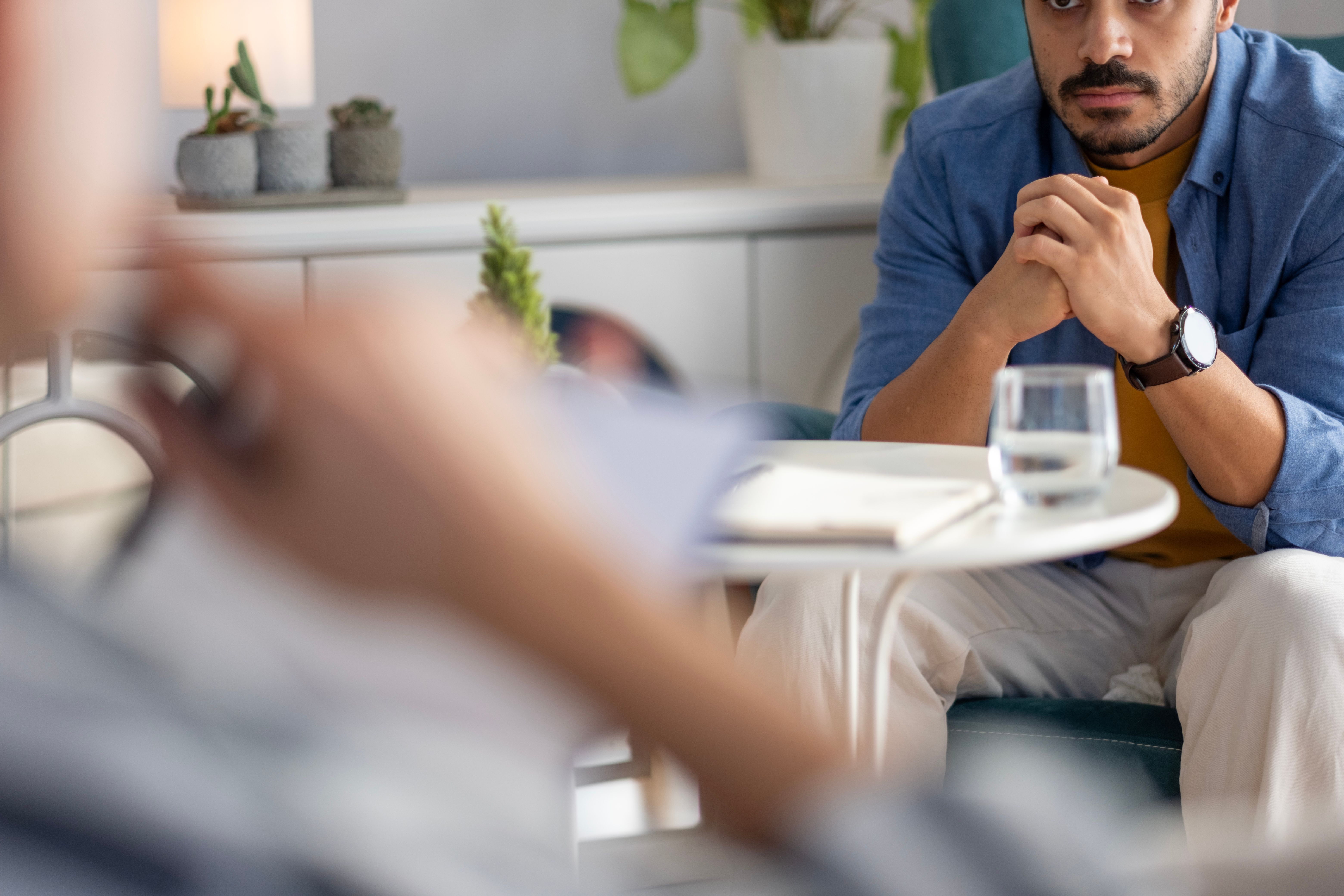 The psychologist listens to his patient with problems at home and takes notes in his notebook The psychologist listens to his patient with problems at home and takes notes in his notebook