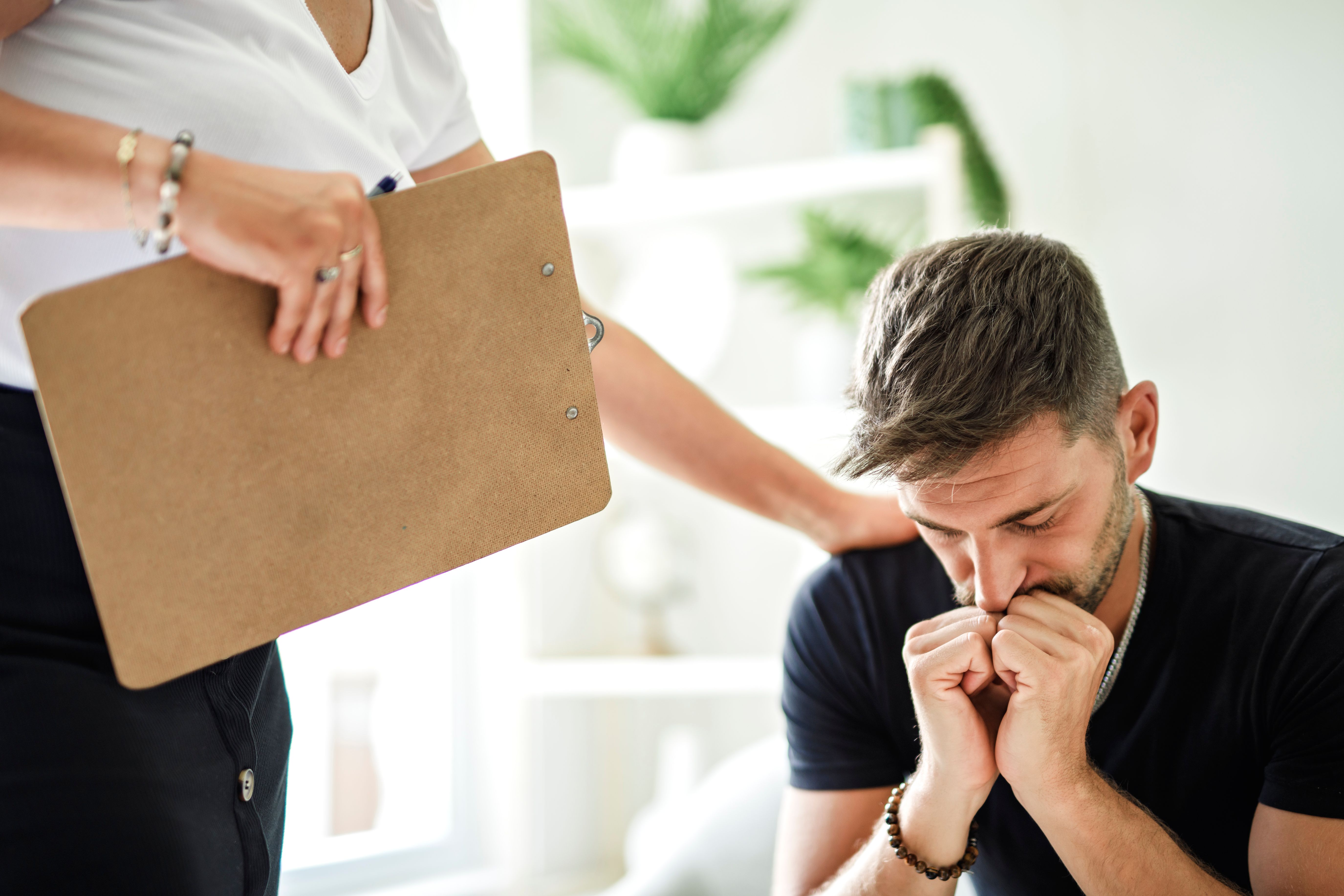 Man with psychologist theraphy social problems concept drug addiction talk to a psychological woman