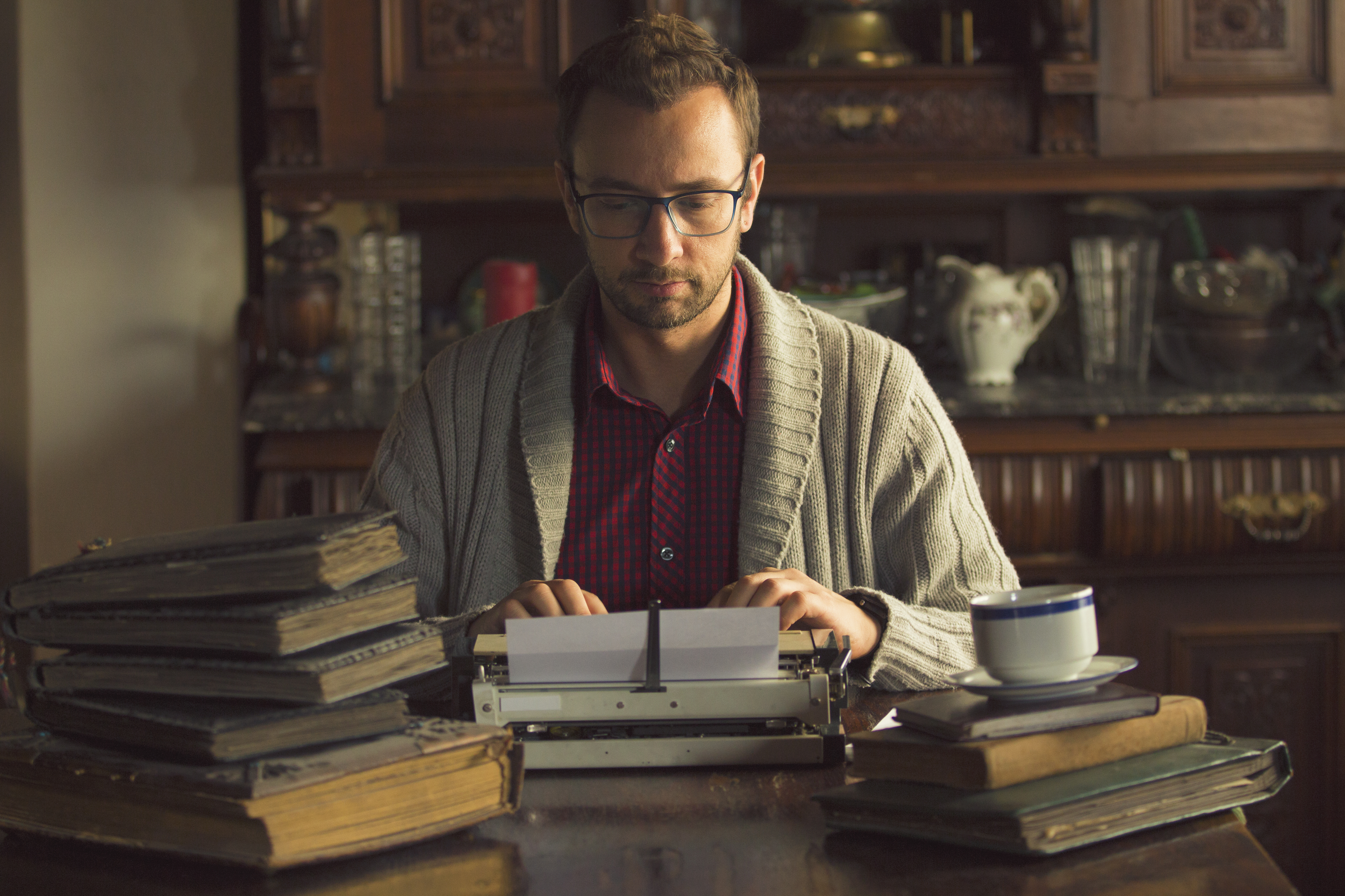 Young man writing on old typewriter. Young man writing on old typewriter.