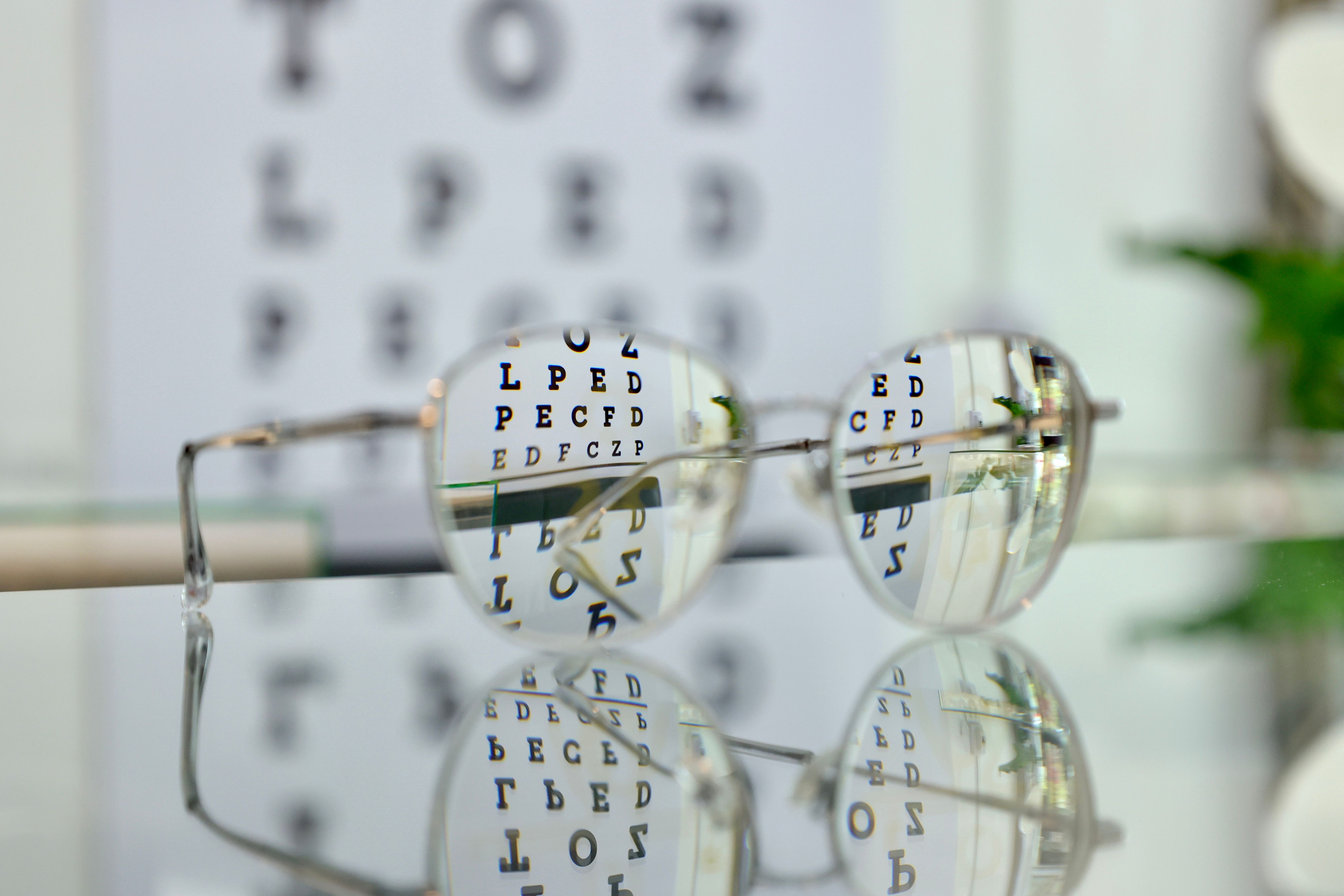 Eyeglasses on the glass cabinet inside the optical shop, progressive lenses, eyeglasses for the elderly, looking through glasses