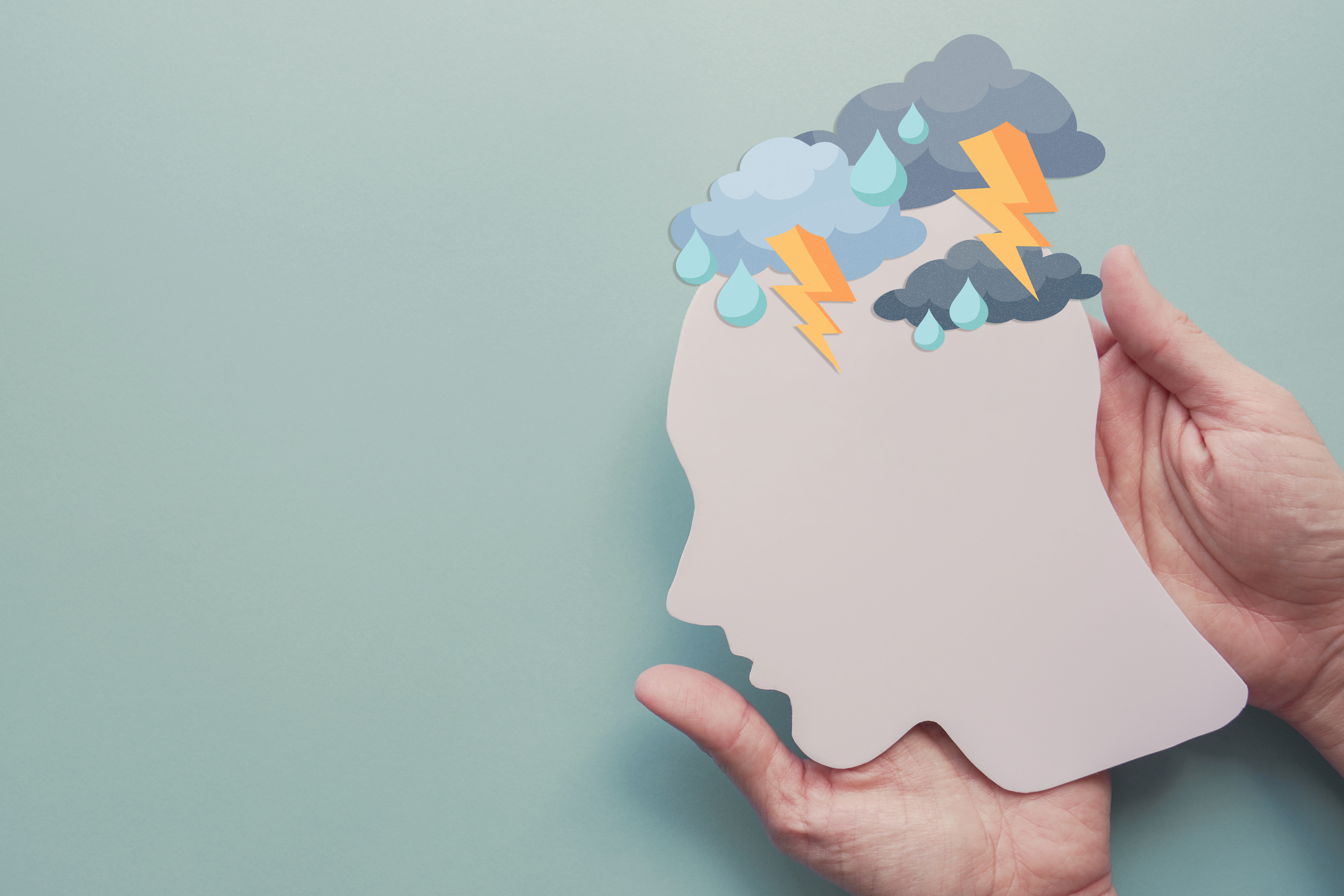 Hands holding paper brain thunder storm, mental health, depression, panic attack concept Hands holding paper brain thunder storm, mental health, depression, panic attack concept