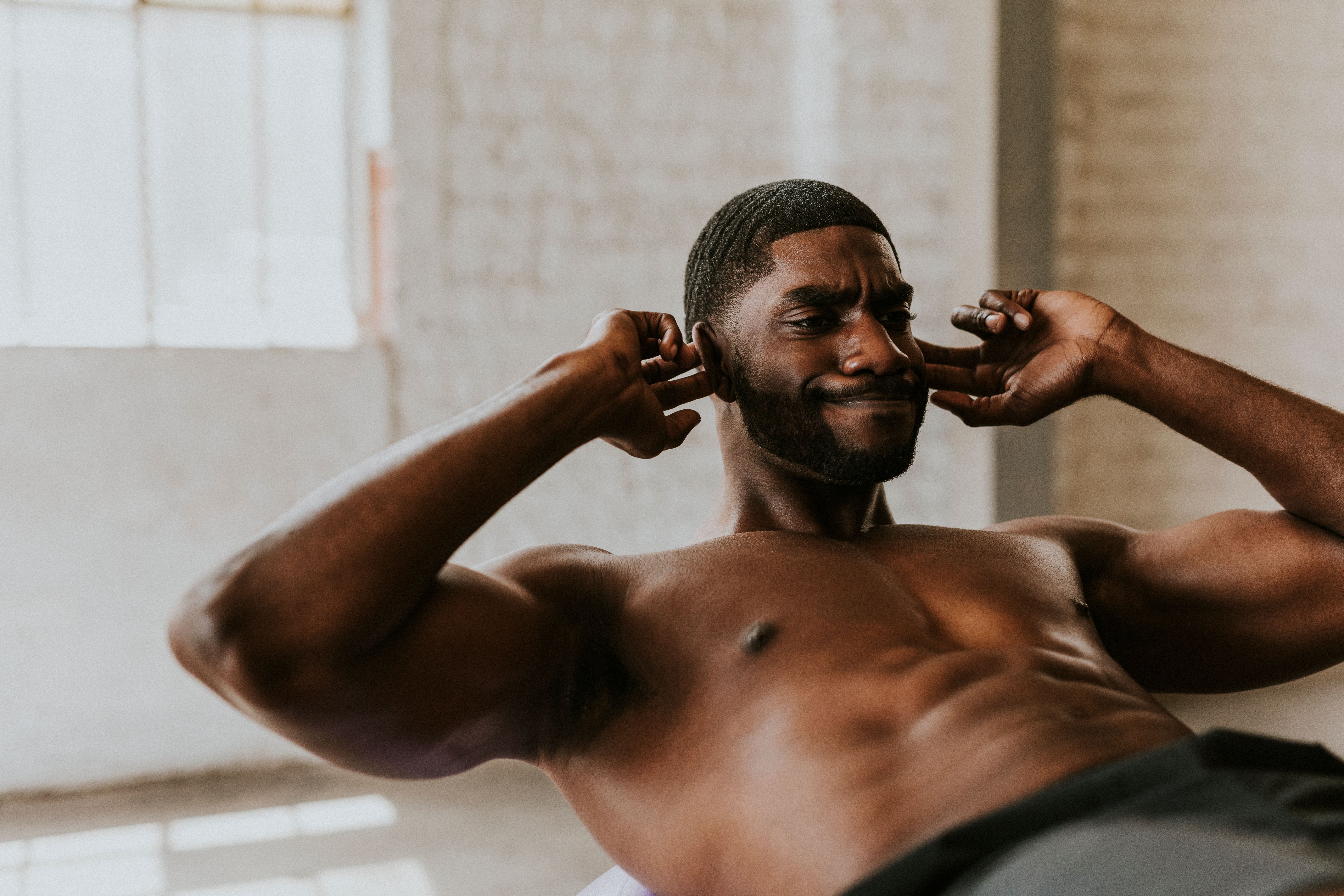 Sportive man doing the sit-ups on a balance ball Sportive man doing the sit-ups on a balance ball