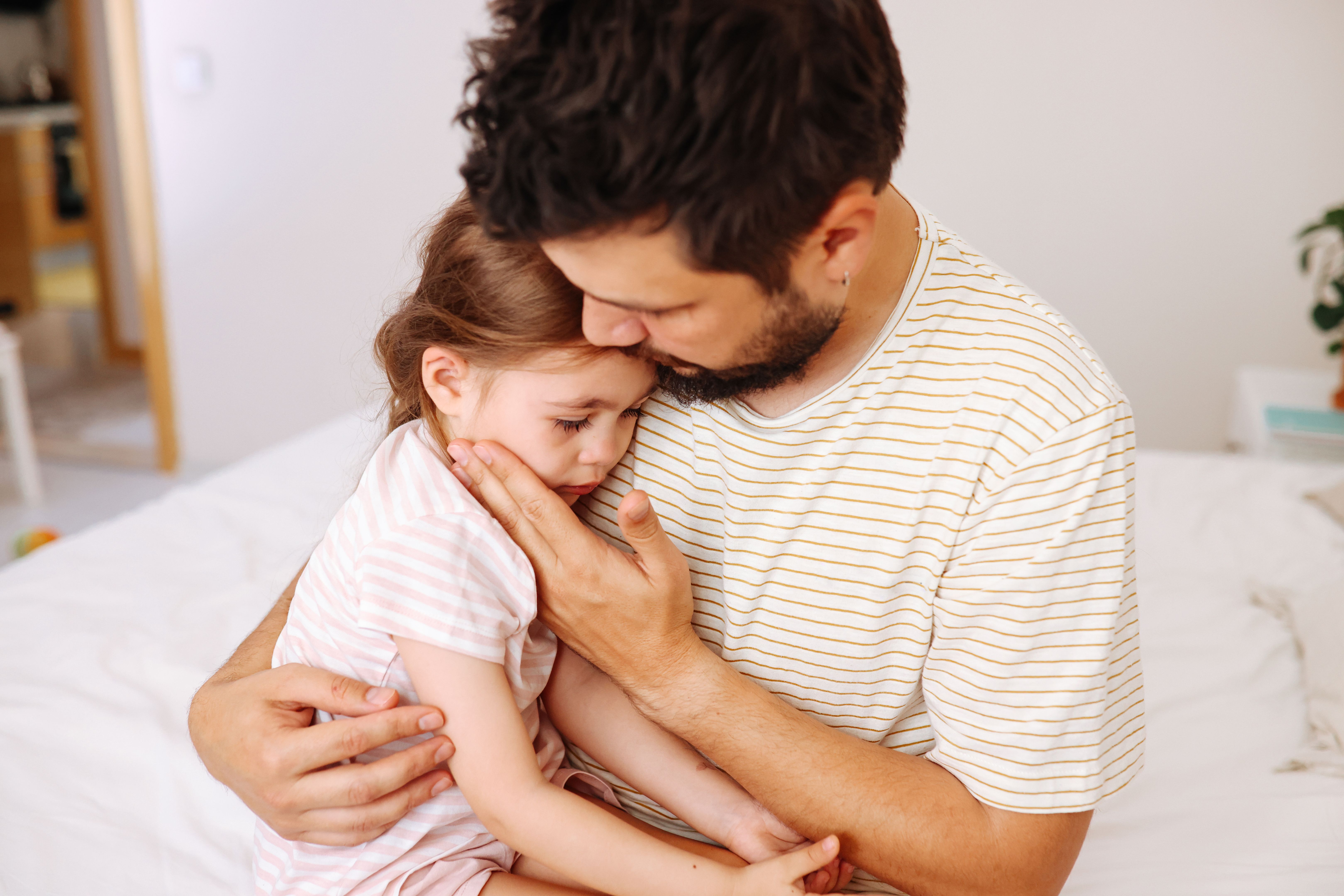 father comforting child