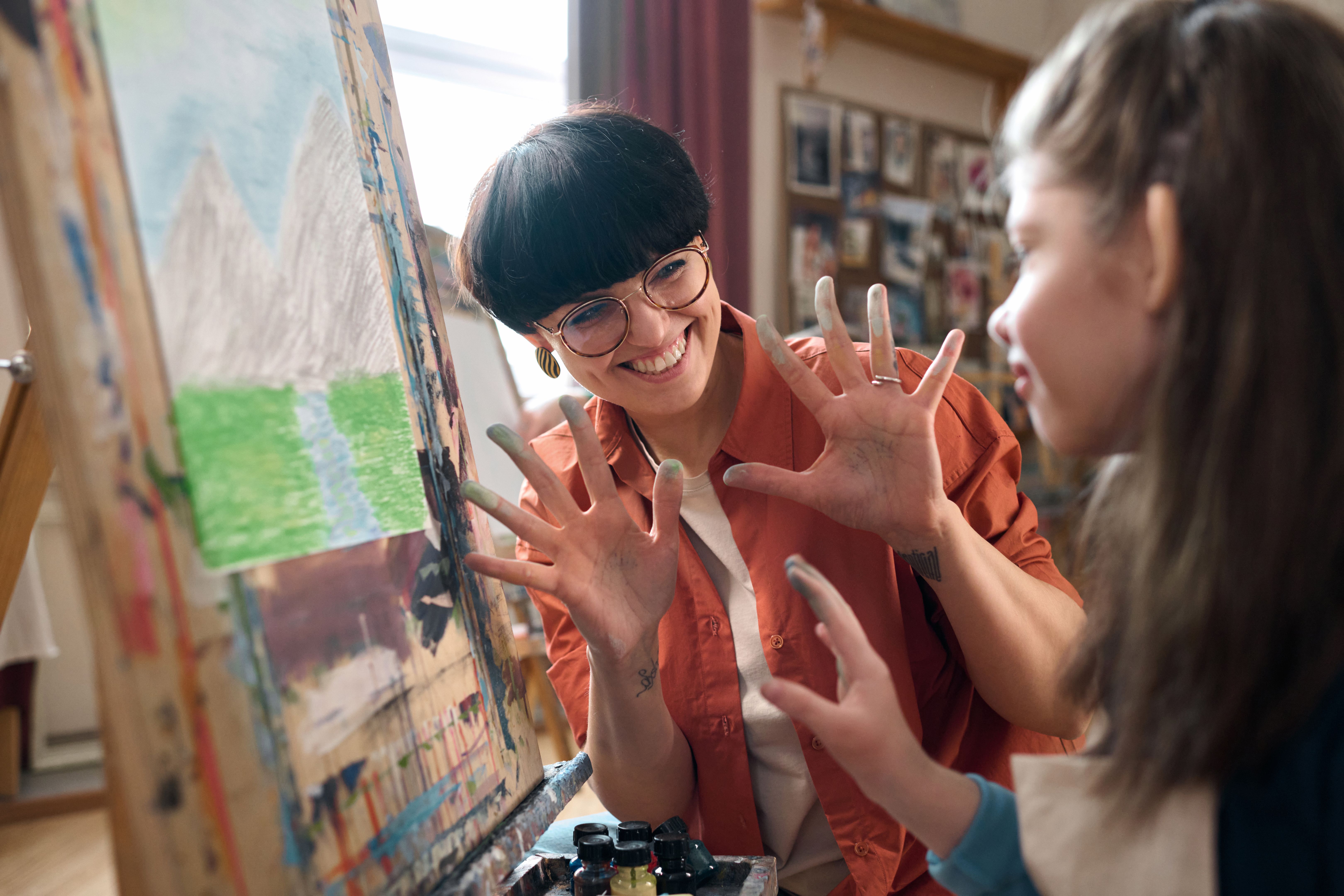 Playful Teacher Working with Children in Art Class
