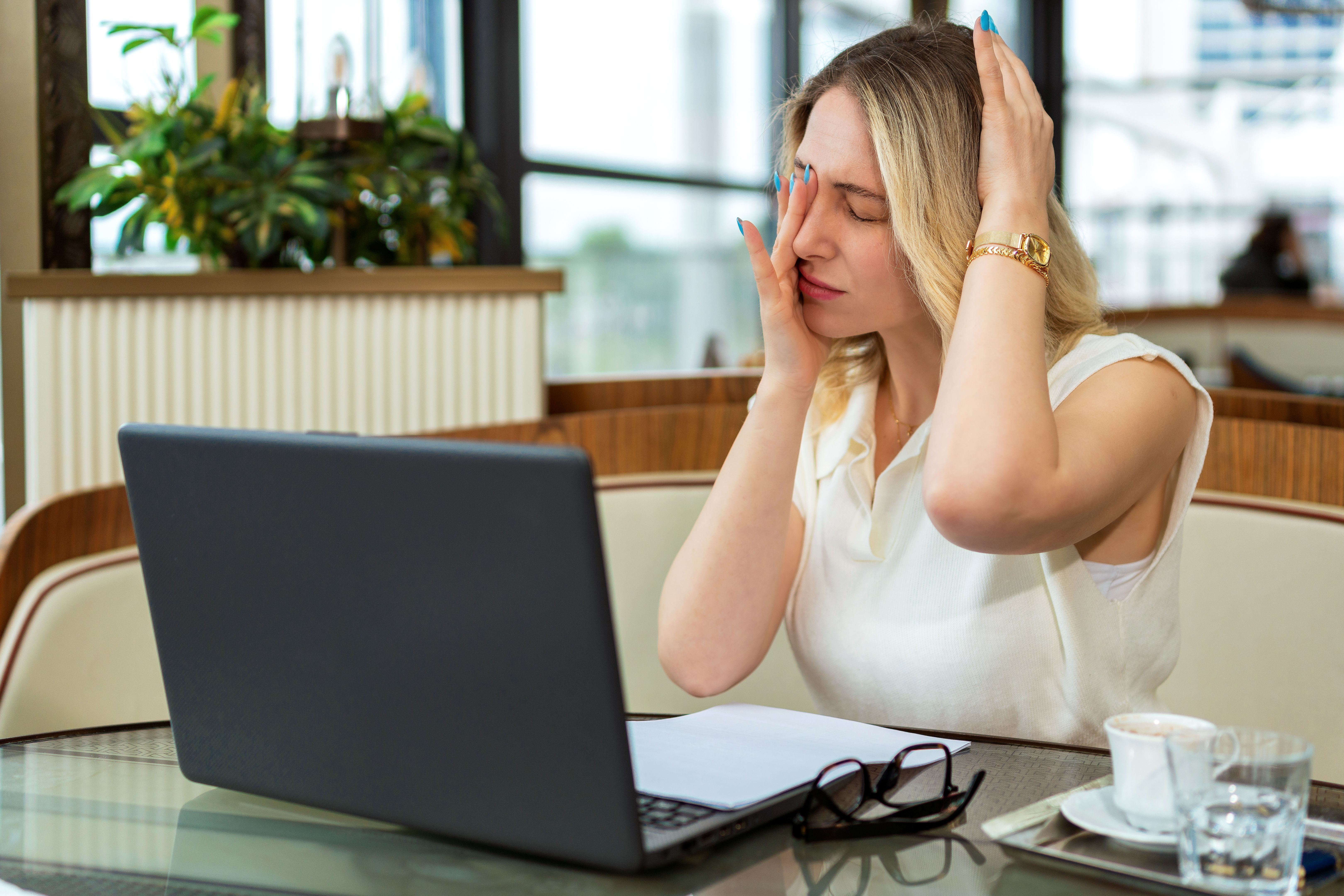 Tired and headache woman after long time working with laptop
