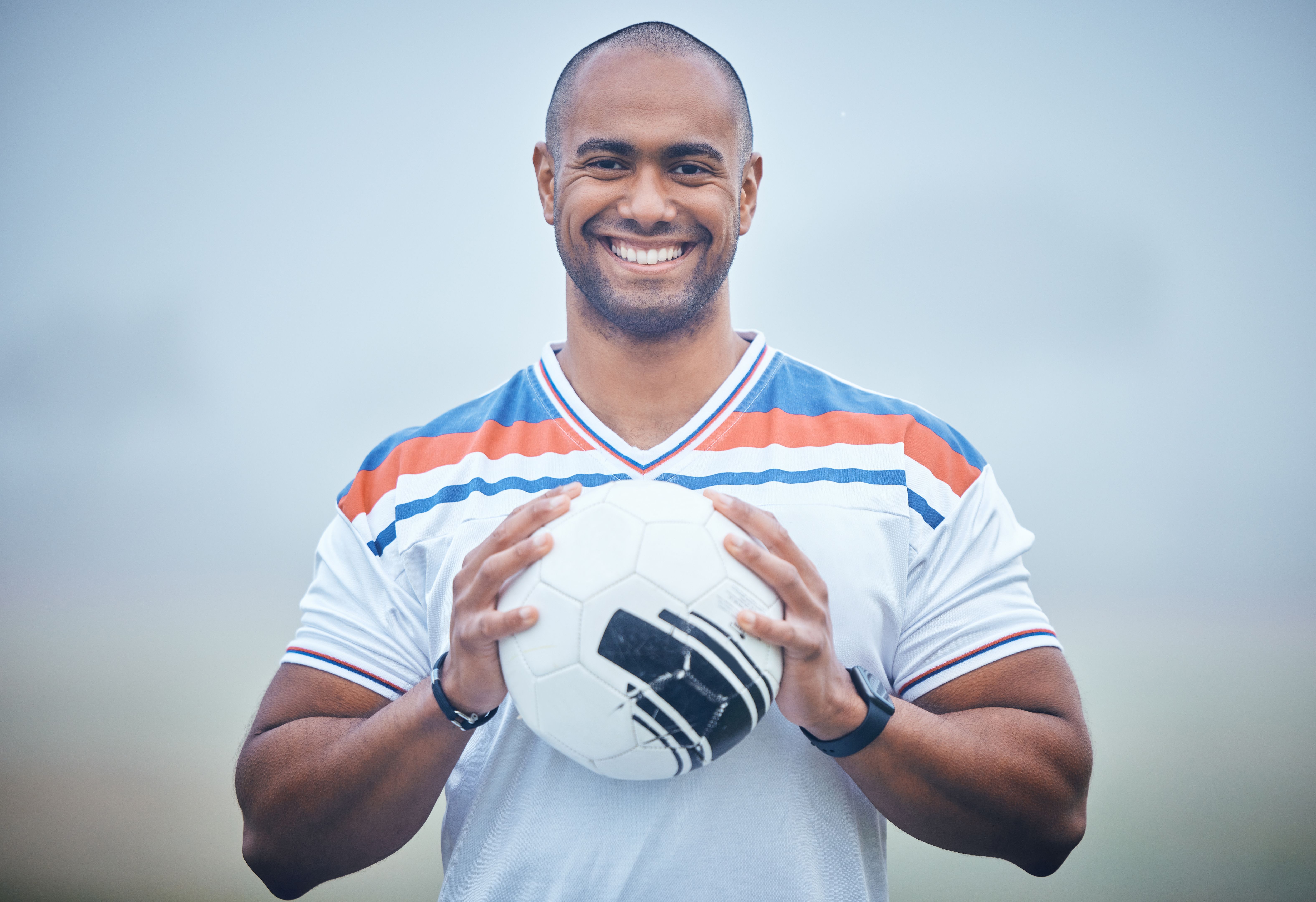 Shot of a young soccer player holding the ball