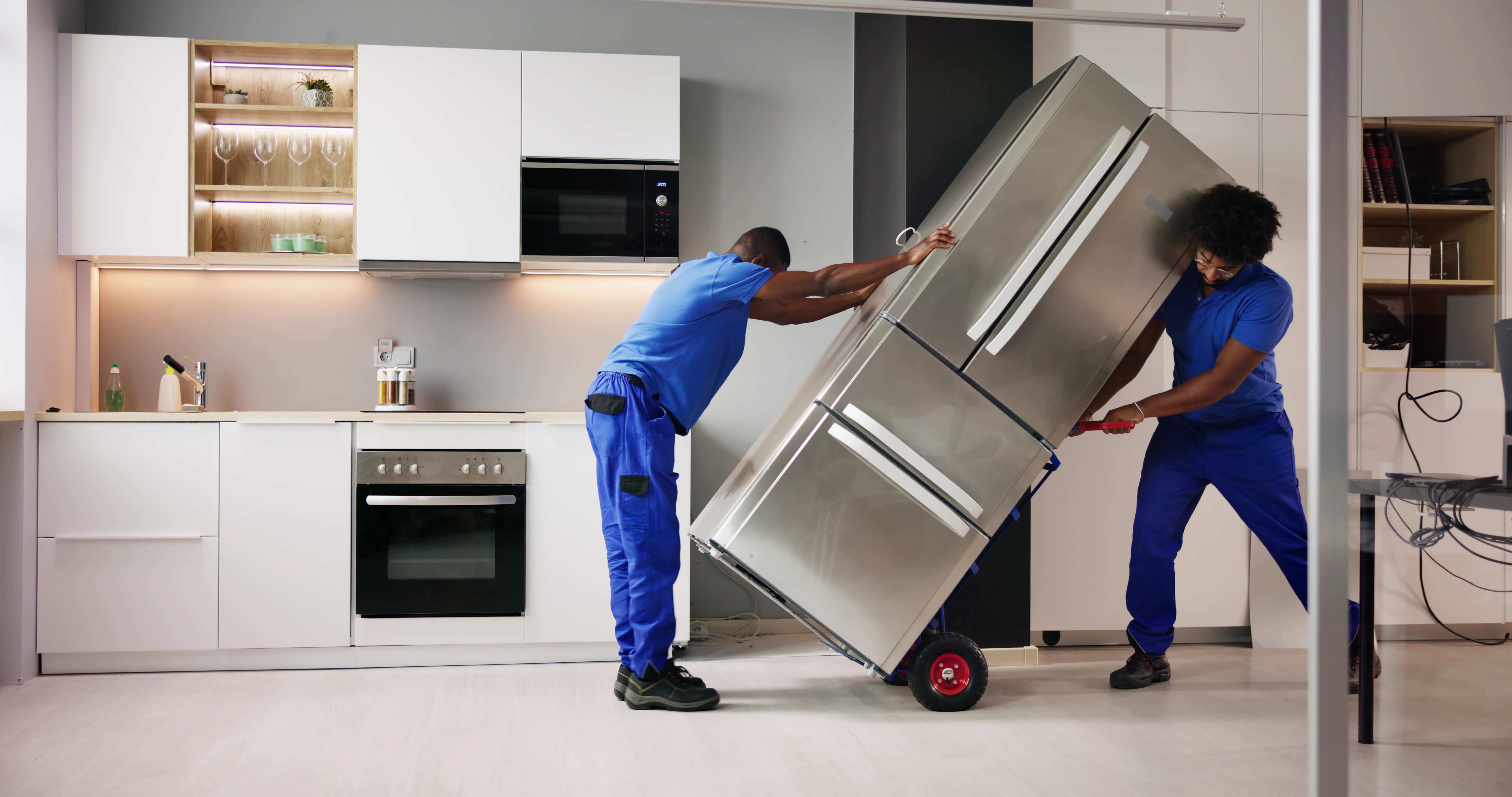 Electrician Technician Working To Repair Refrigerator