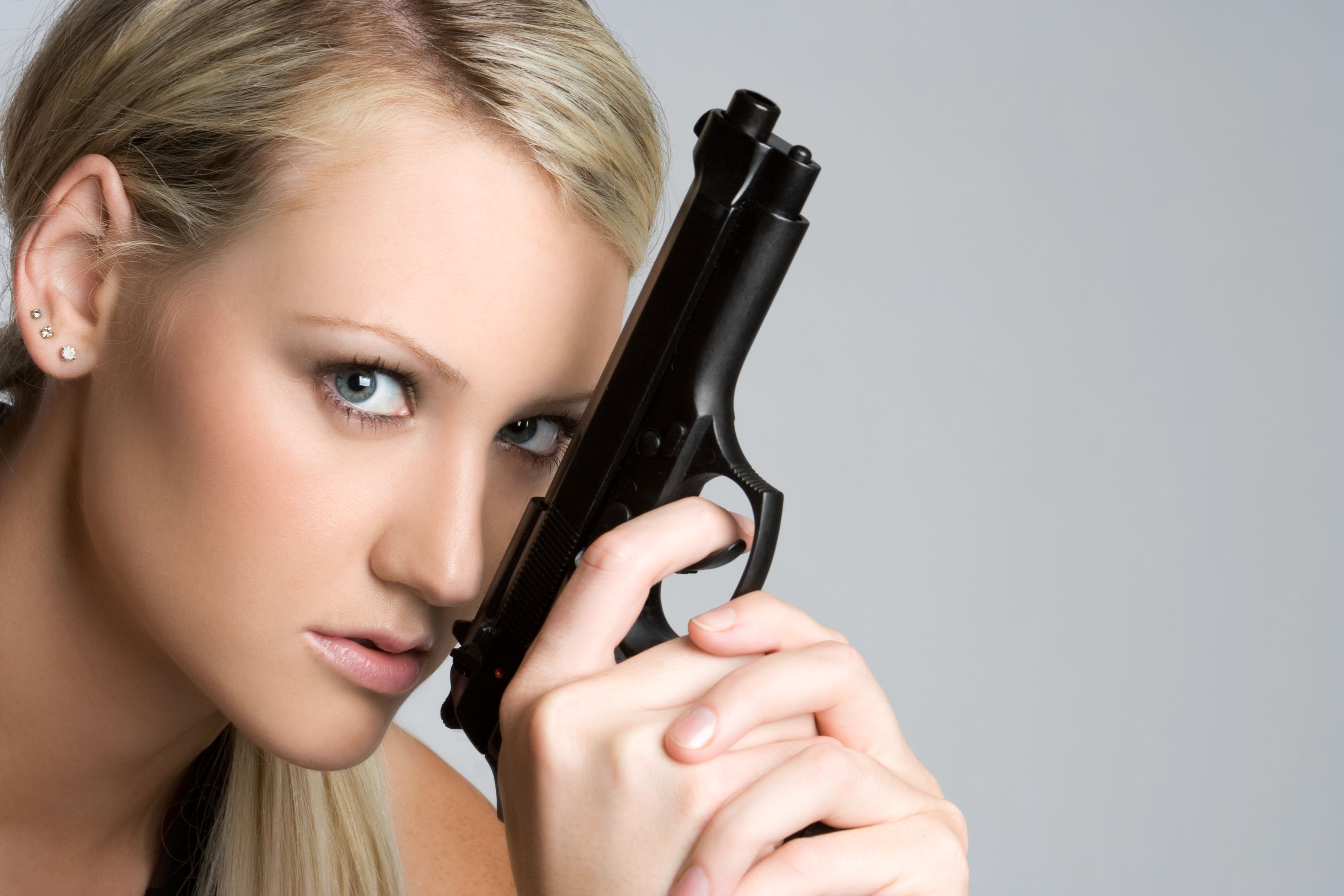 Woman Holding Handgun