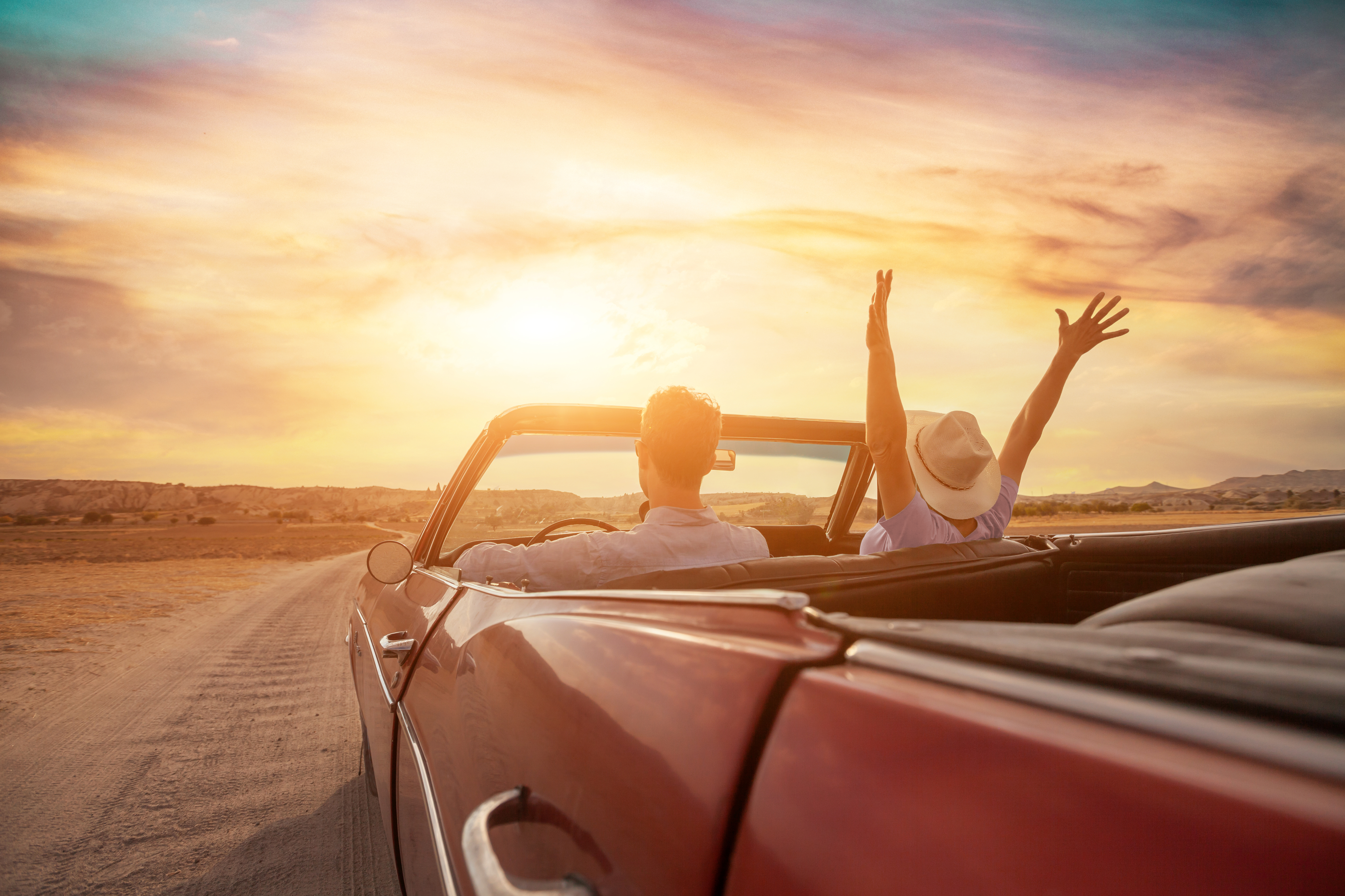 happy people traveling in classic vintage car, couple on honeymoon