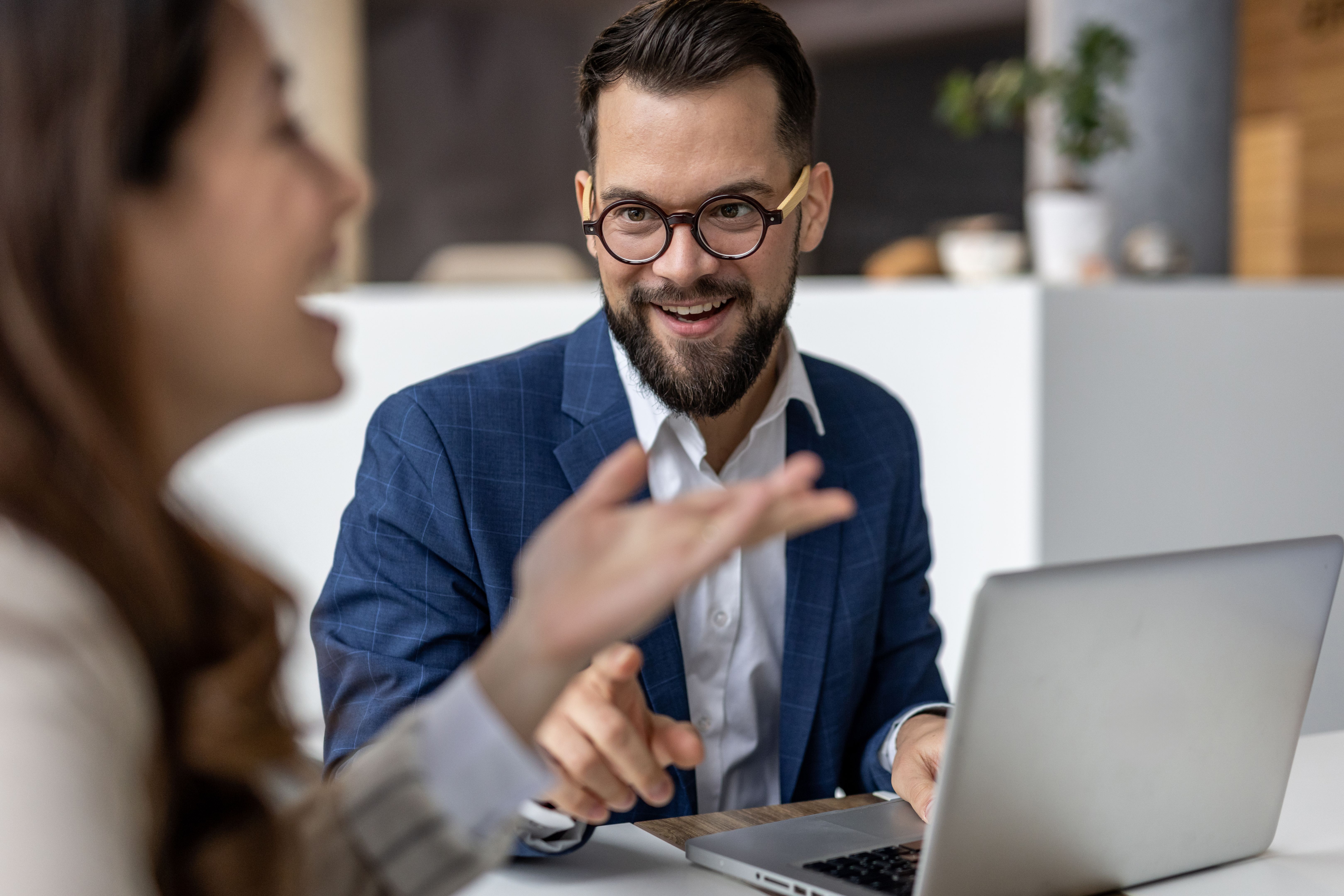 Businessman explaining strategy to colleague using laptop