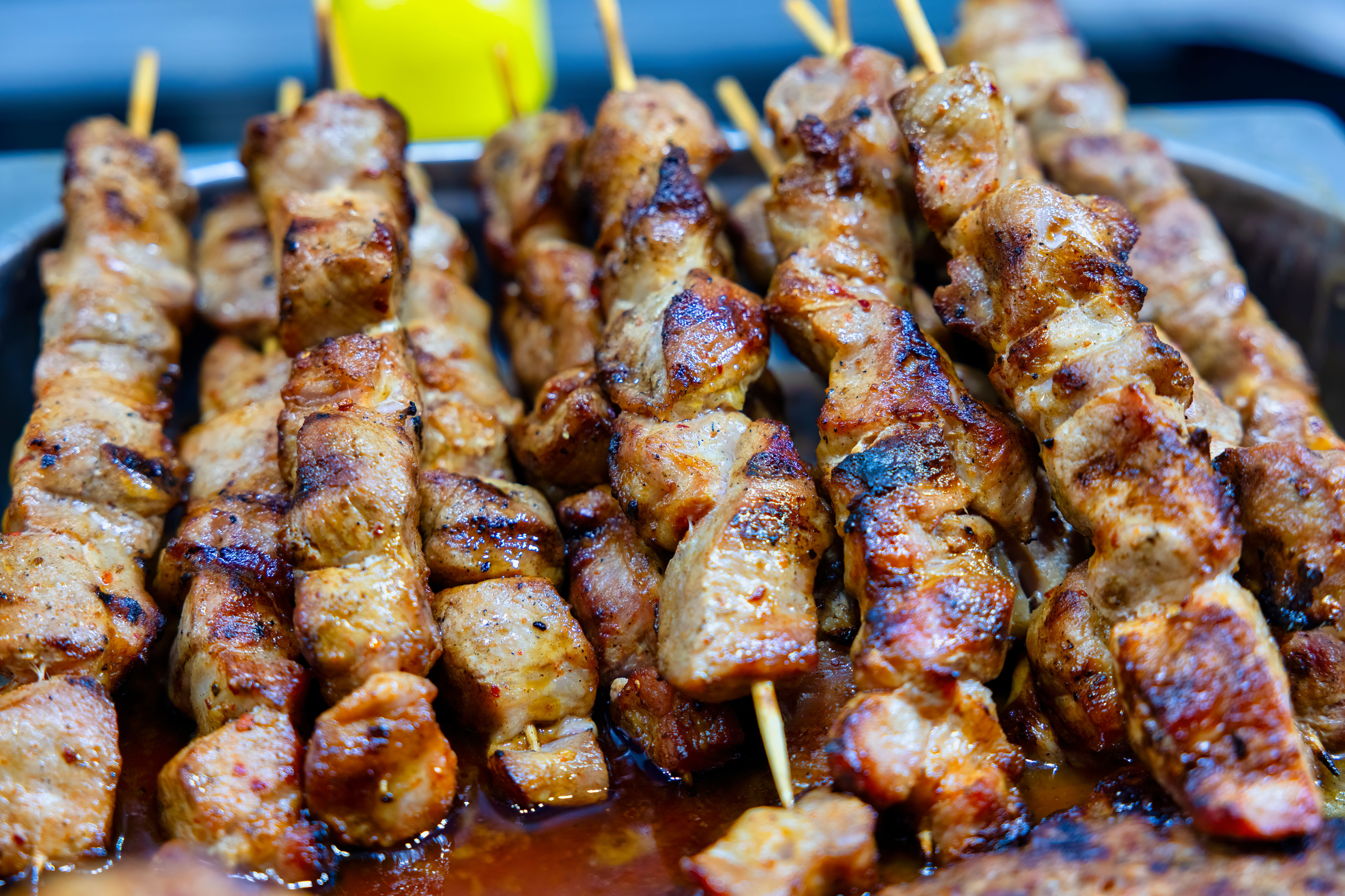 Stacked skewers that have been grilled on charcoal grills