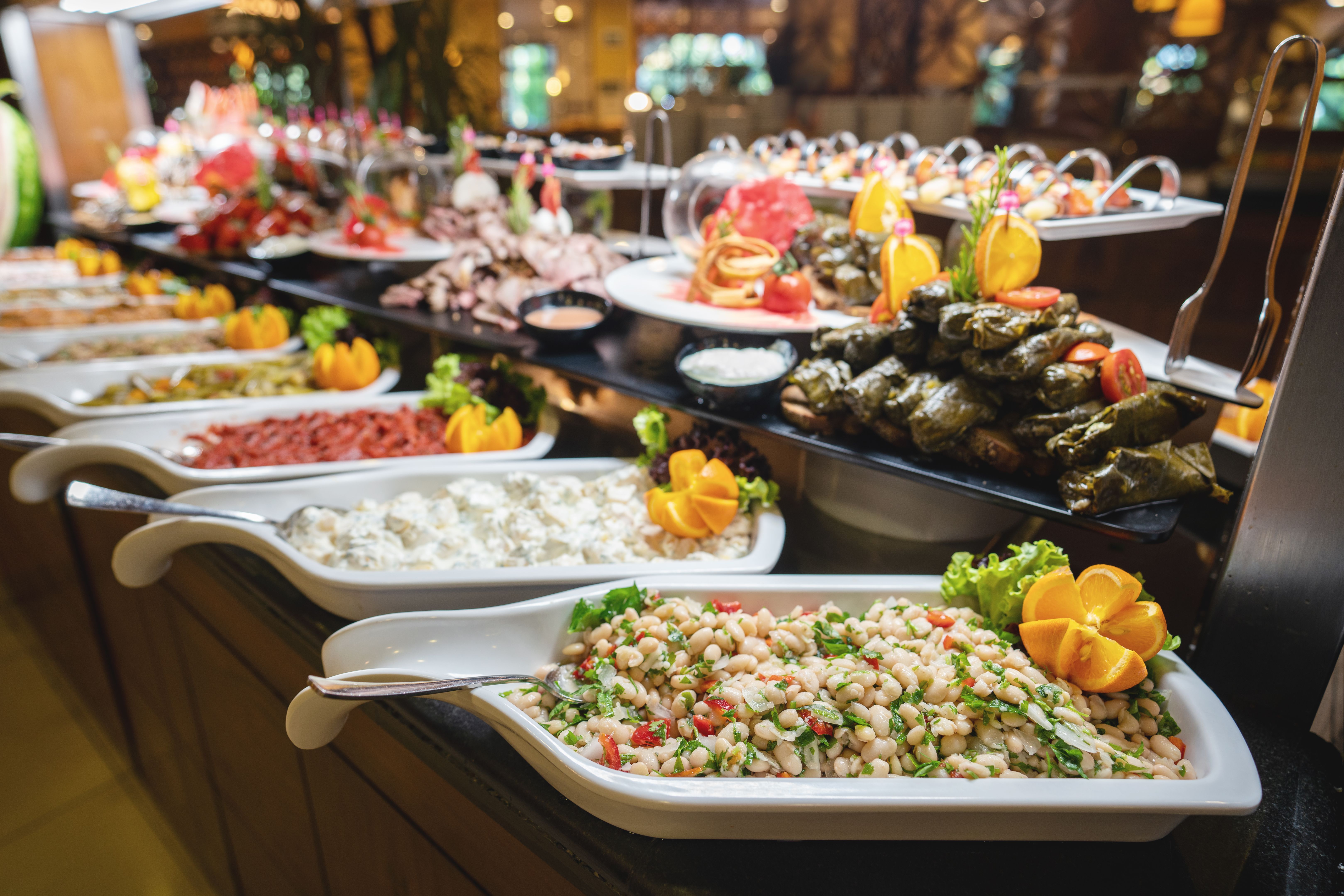 A delicious appetizer and salad buffet with various options in a restaurant or hotel A delicious appetizer and salad buffet with various options in a restaurant or hotel