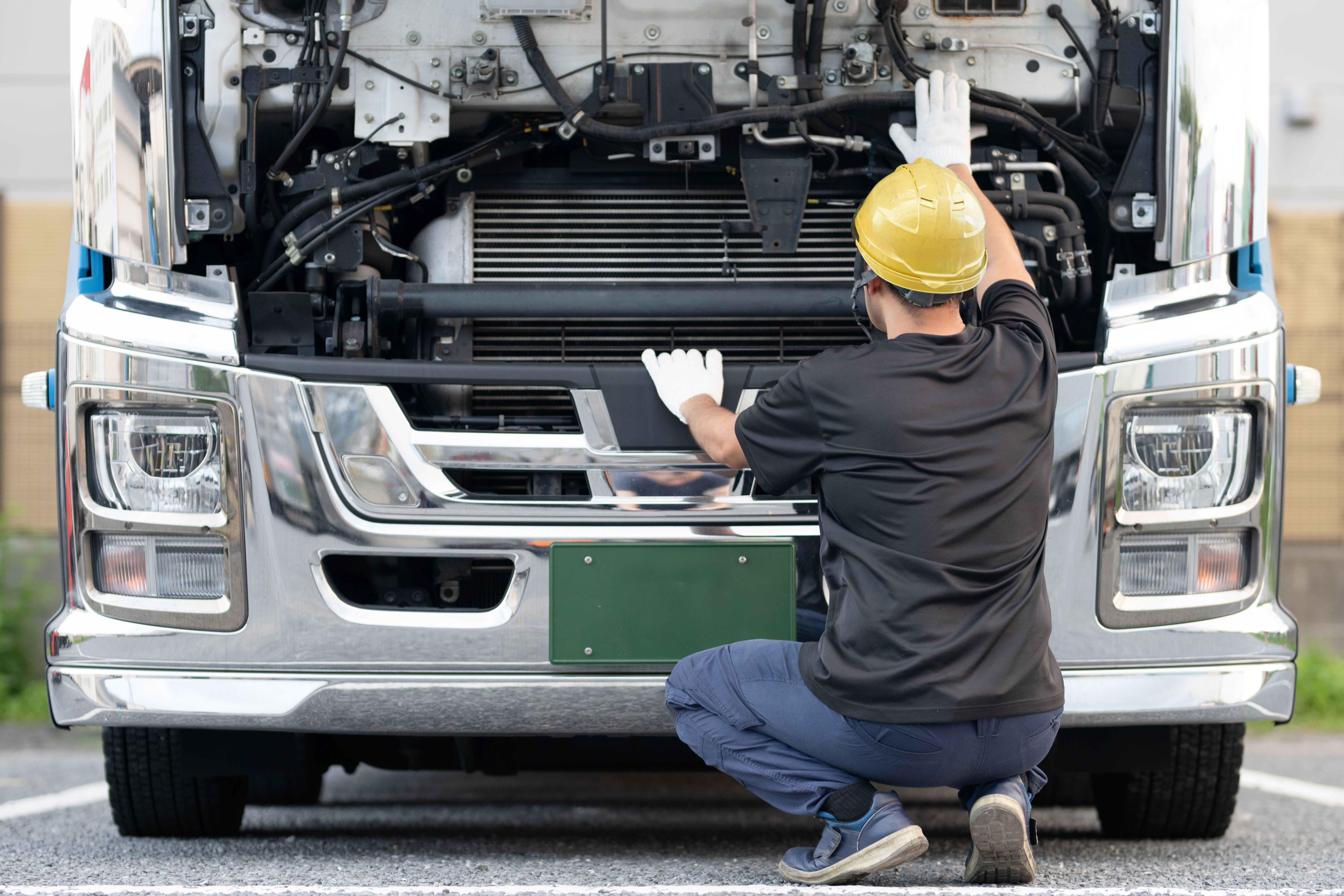 A man inspecting a large truck