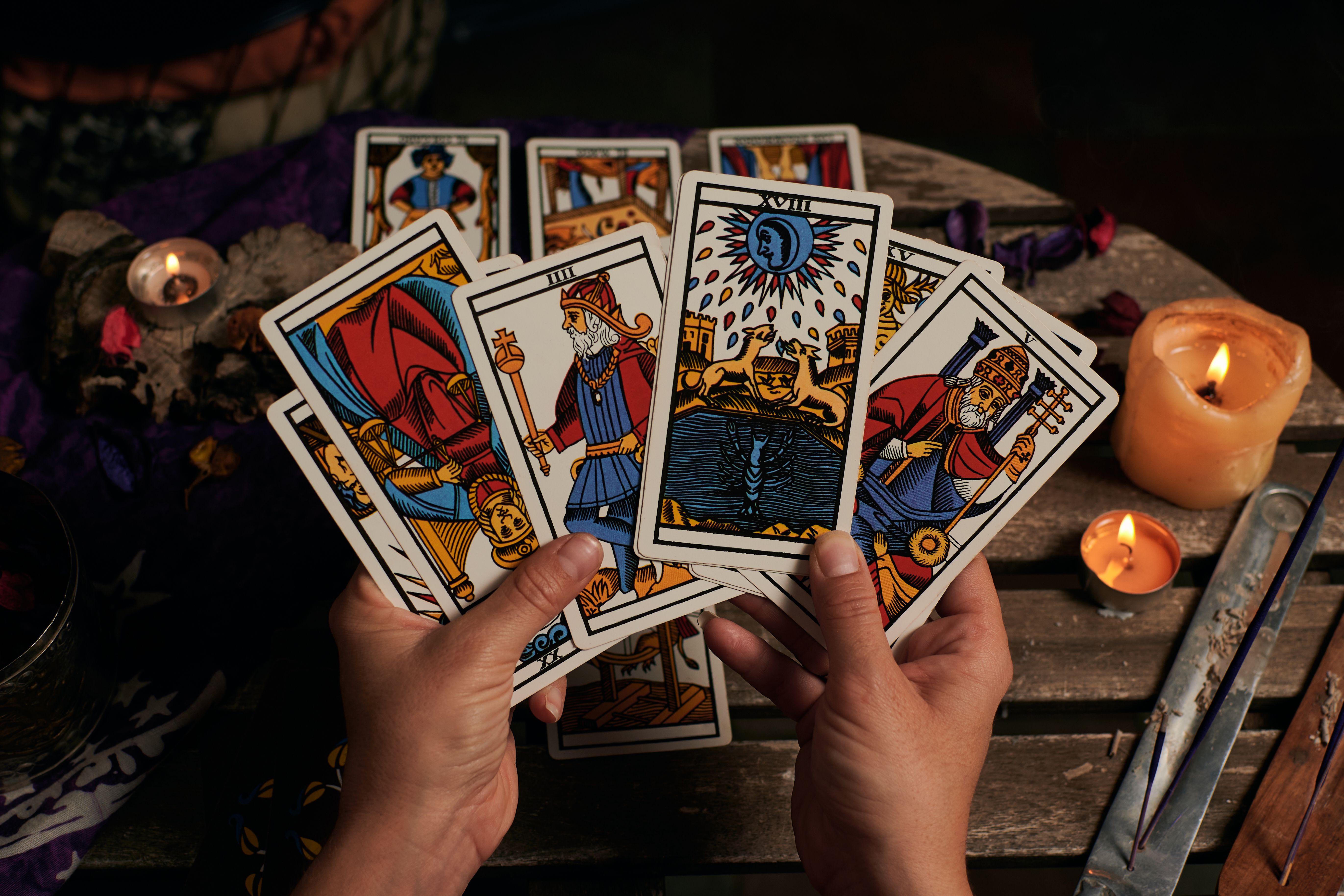 person with tarot cards