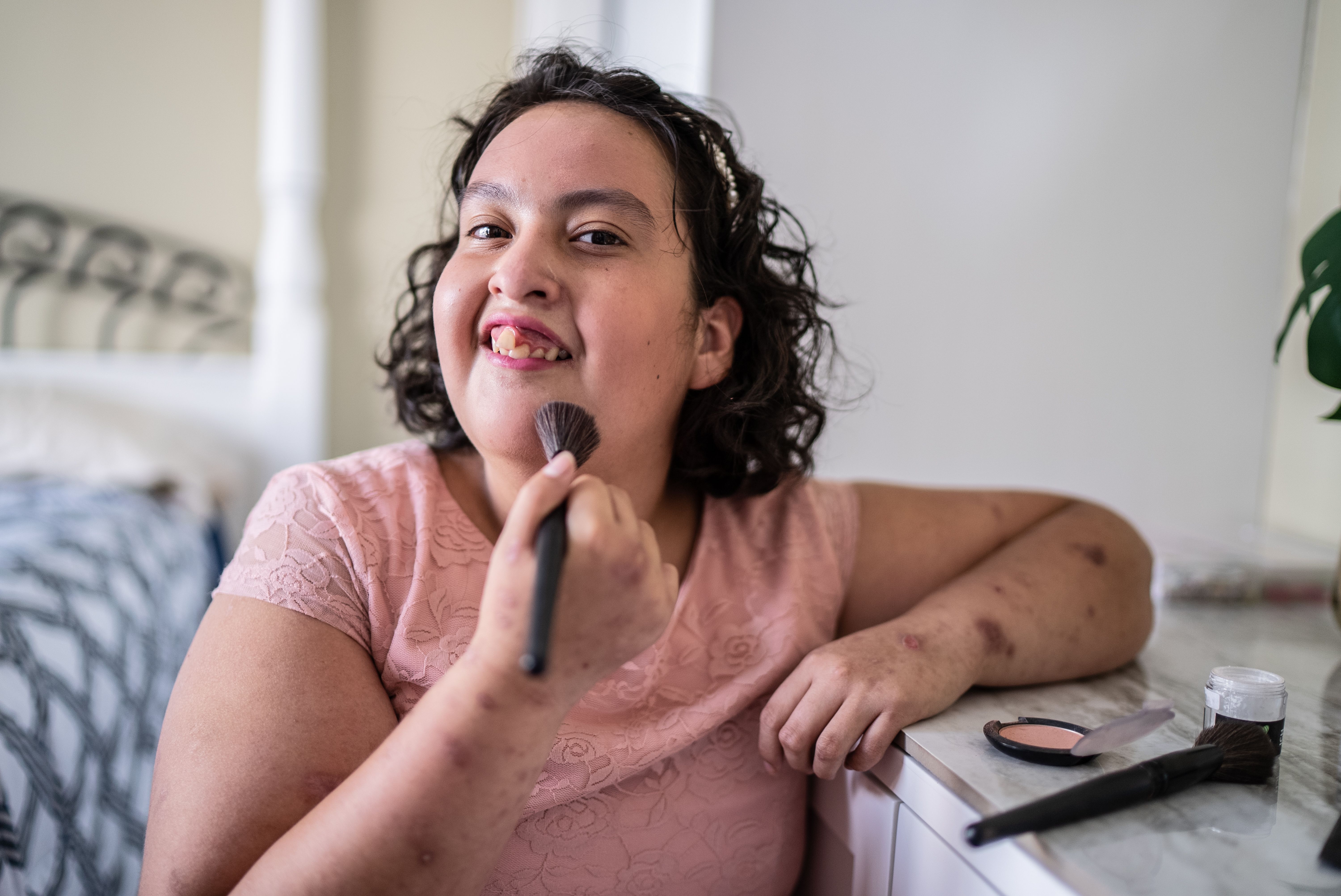 Psychomotor Intellectual disability girl doing her makeup at home