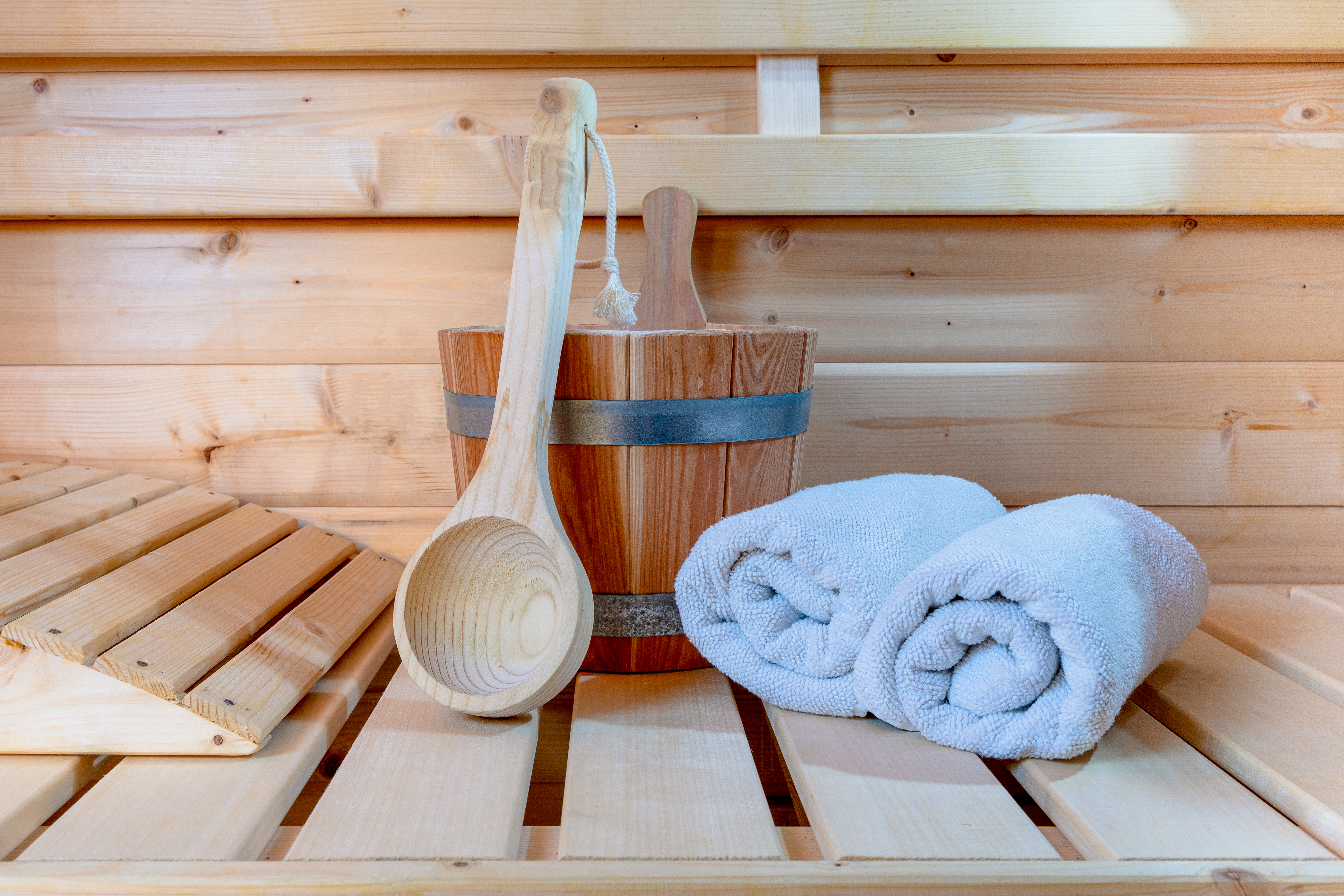 Detail from buckets and white towels in a sauna, wellness accessories