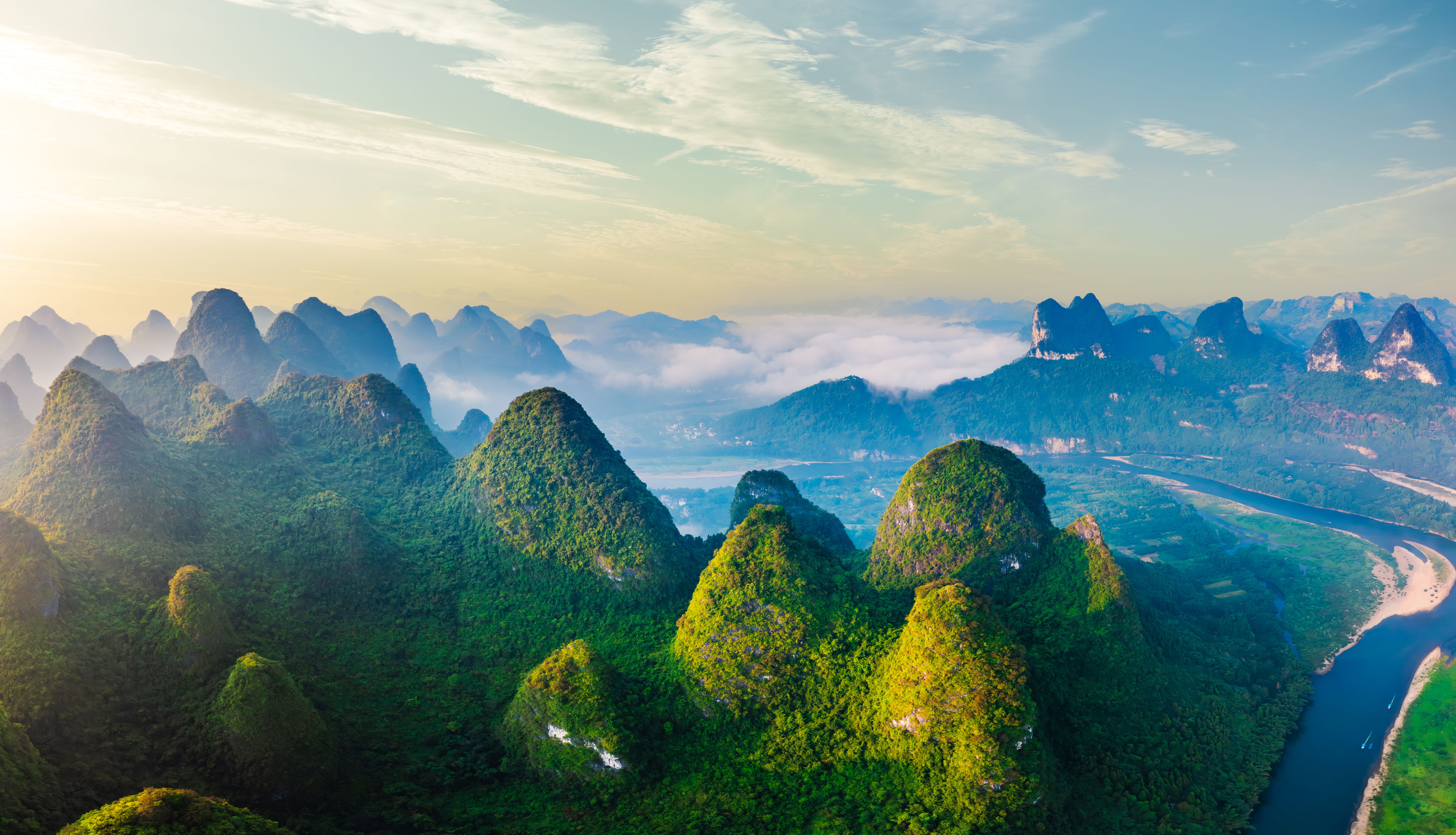 Aerial view of the beautiful karst mountains and sky clouds natural landscape at sunrise in Guilin, China.