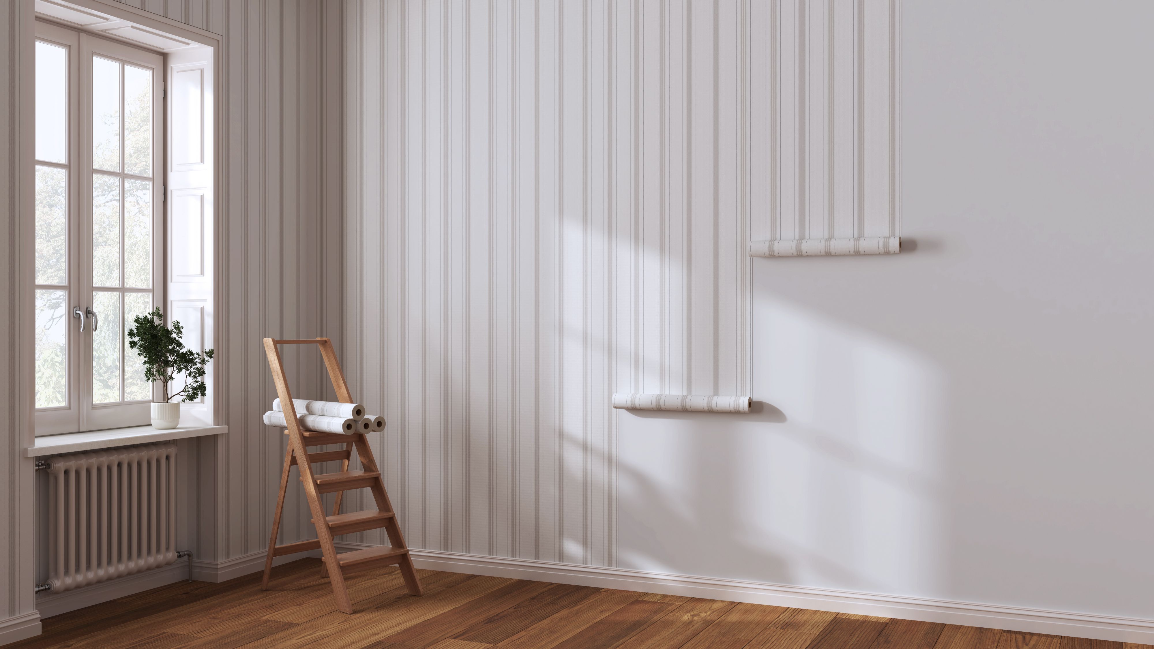 Empty room with white walls and parquet floor, shits of striped beige wallpaper on the wall with copy space. Housework concept