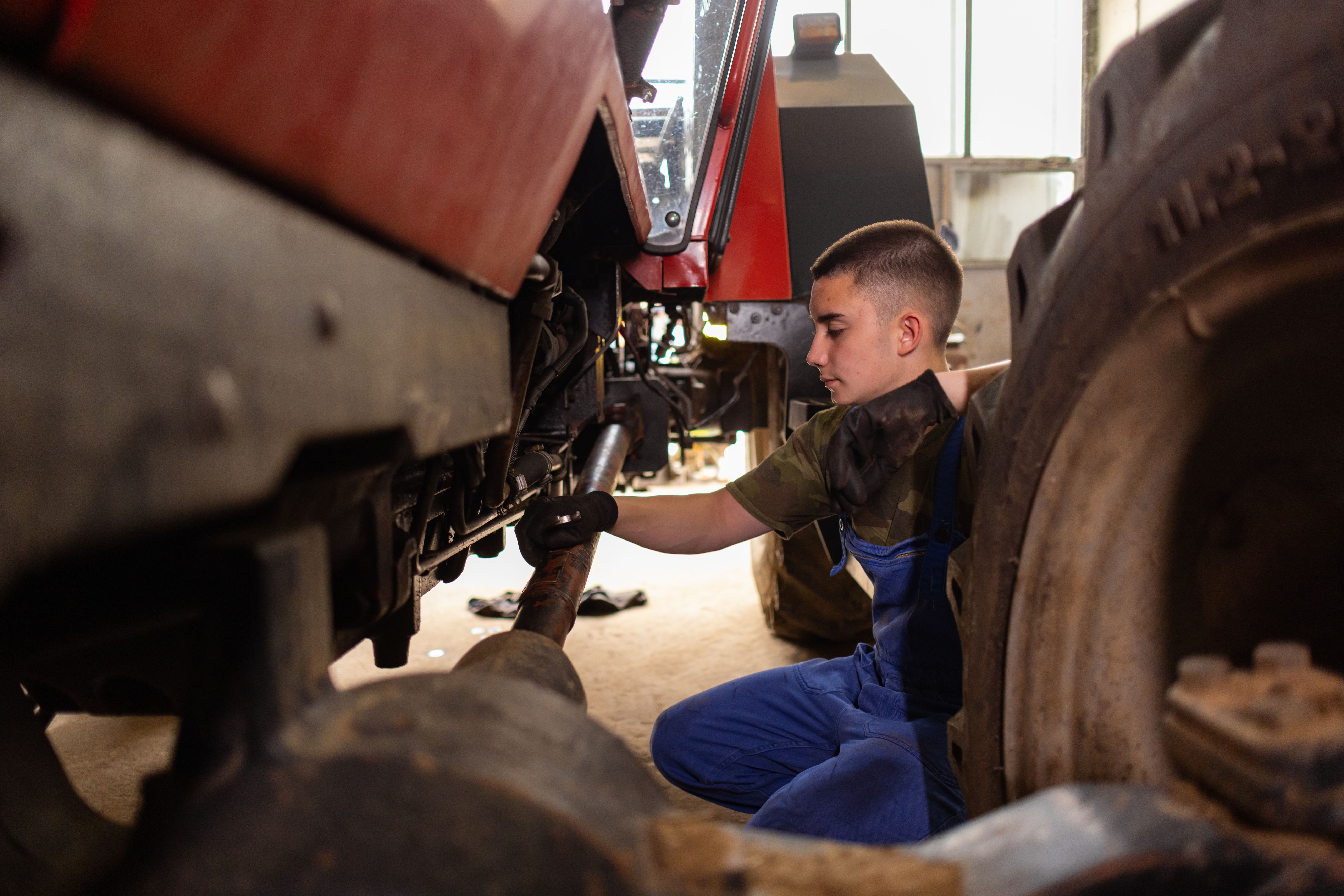 mechanic inspecting tractor
