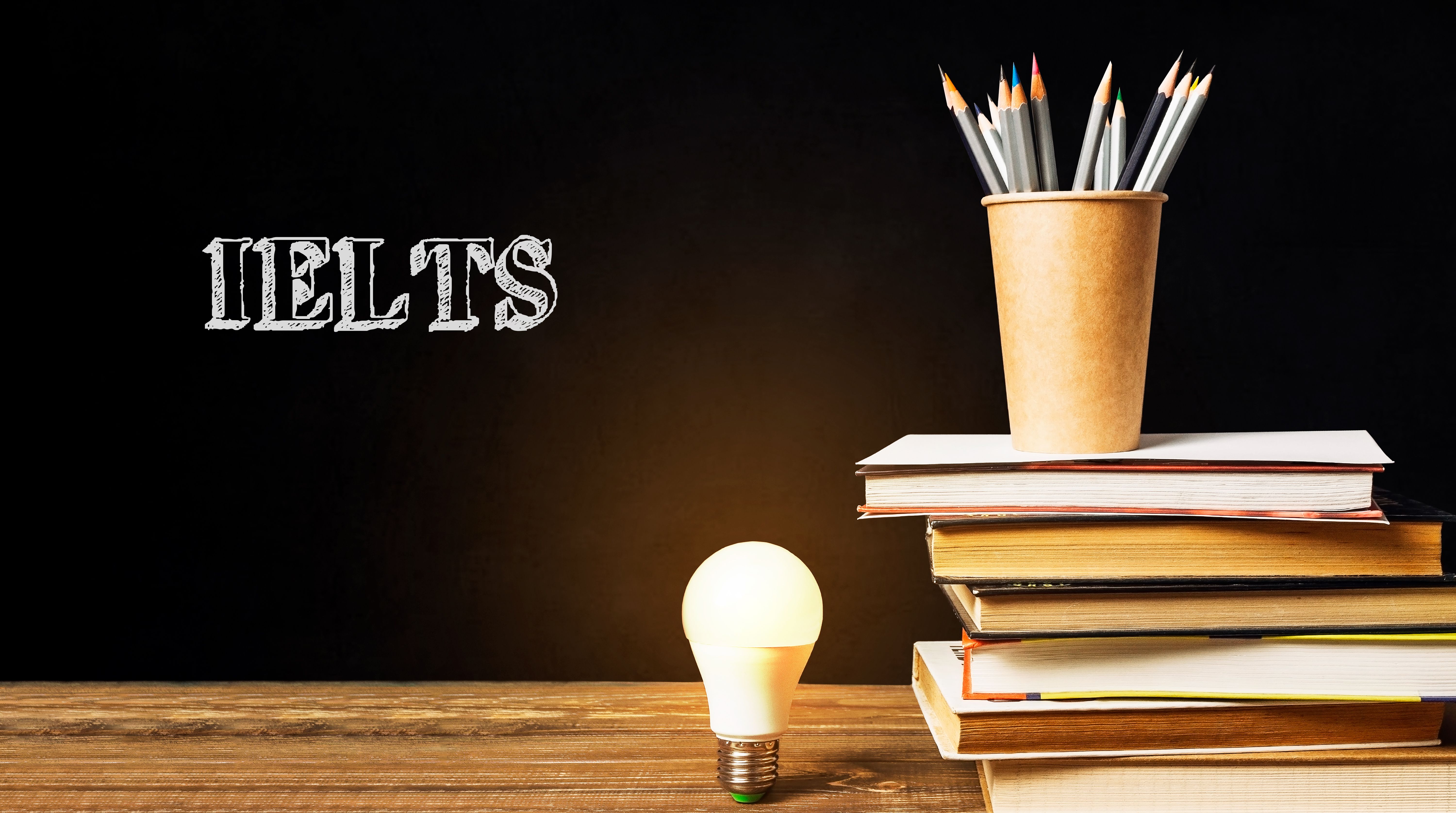 A stack of books with a light bulb on top of them