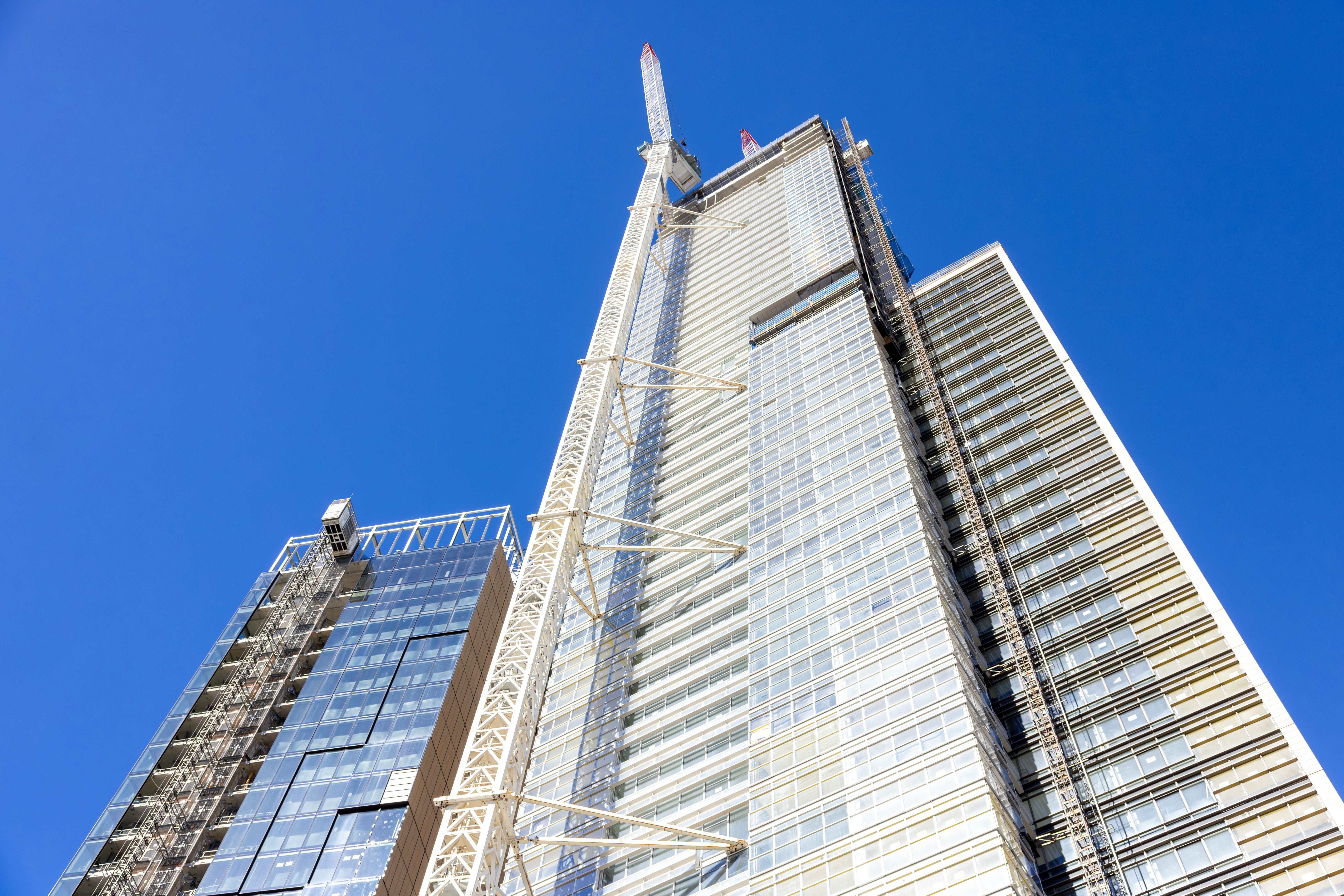 Construction of skyscrapers in the city, blue sky background with copy space