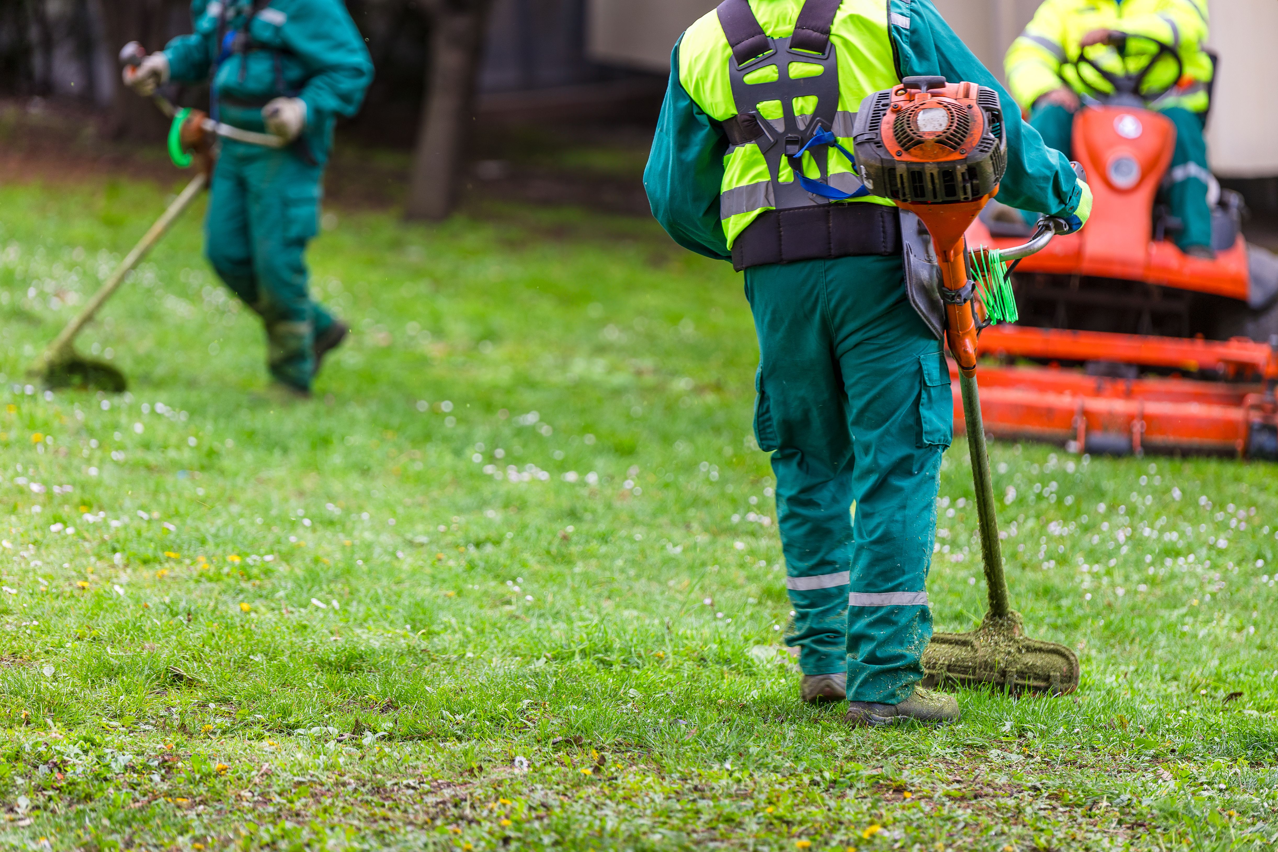 Landscaping crew working with lawn equipment