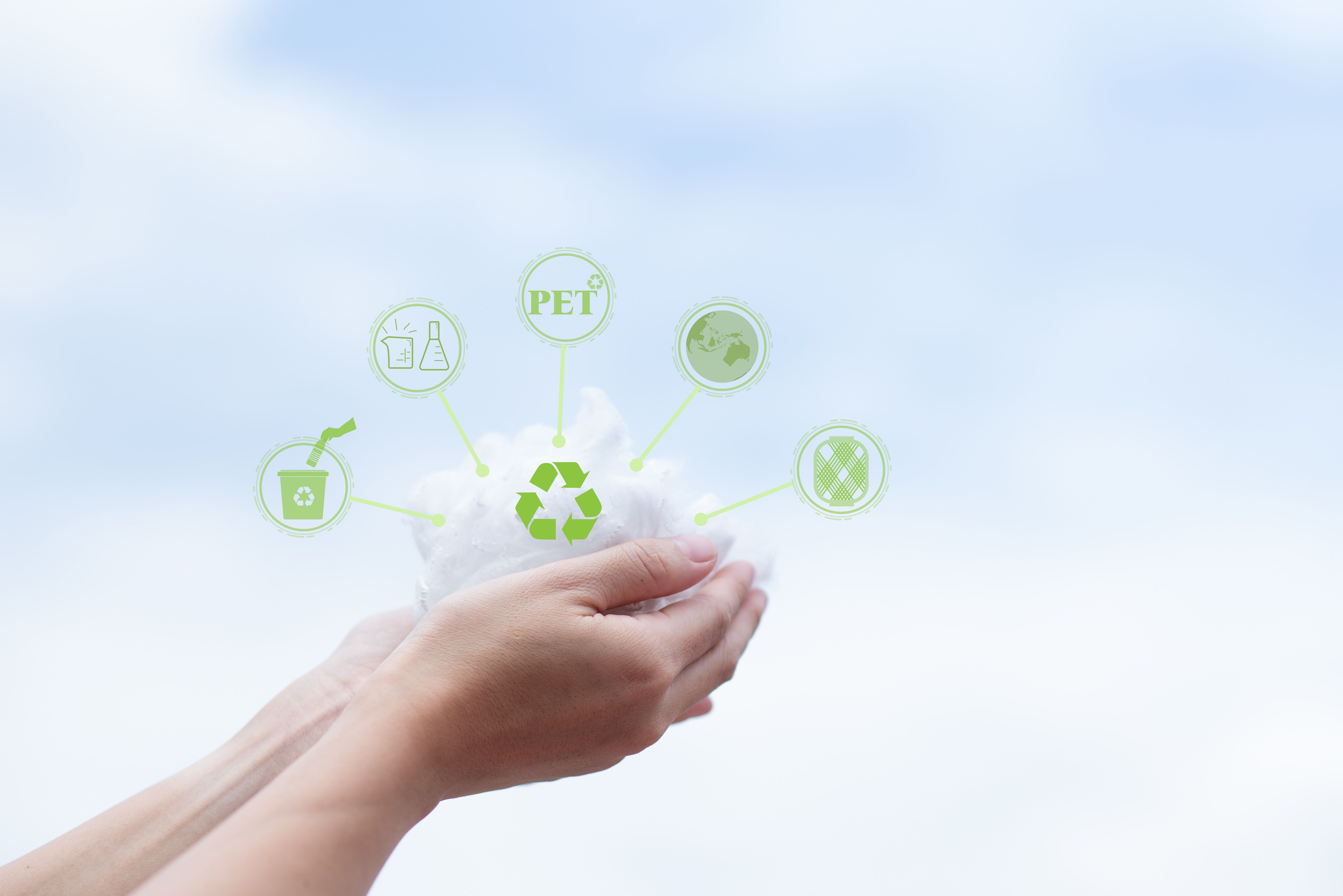 Hands holding polyester staple fiber with blue sky background. Recycle icon, sustainable icon and Bottle icon. Chemical concept.