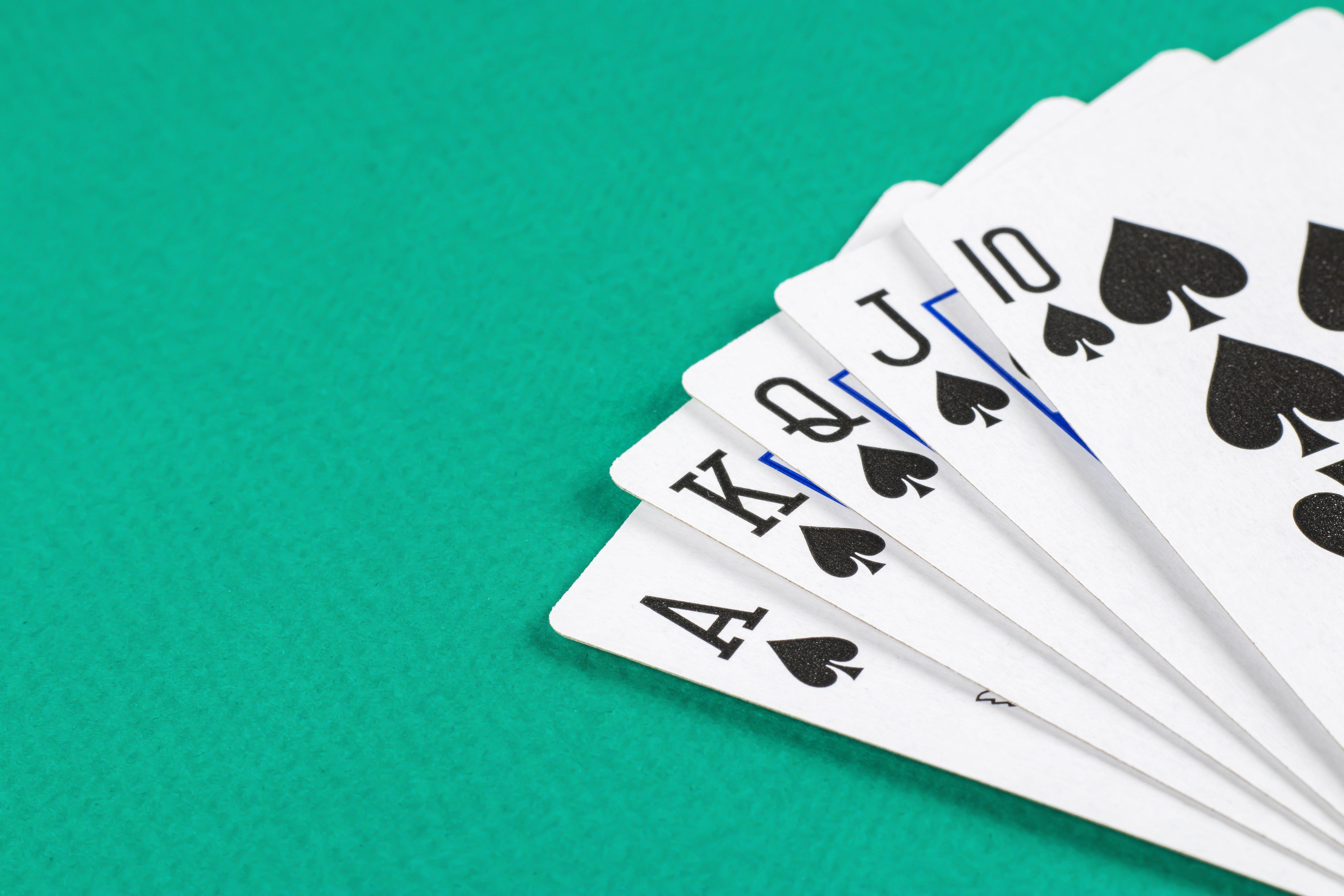 Playing cards on green background.