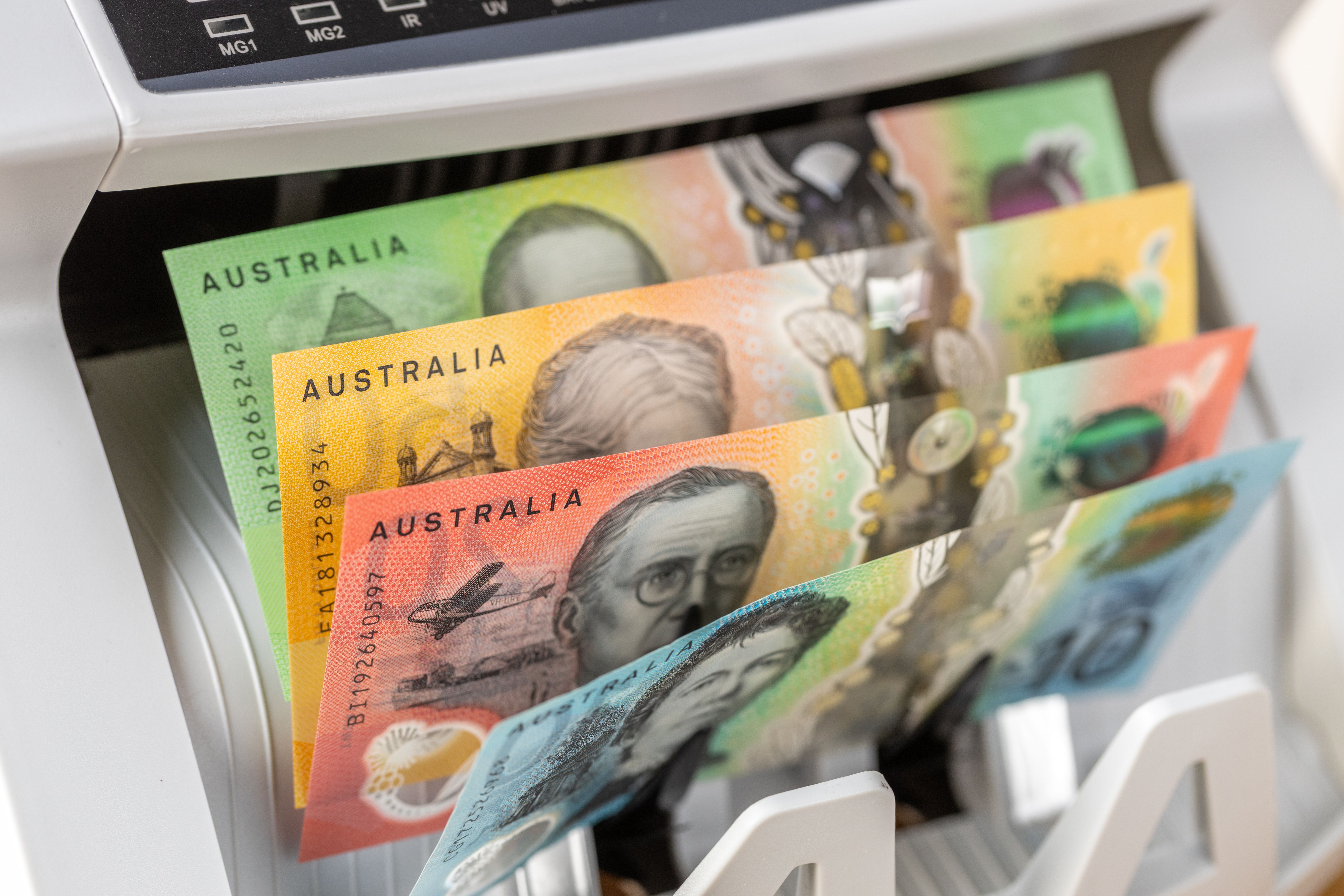 Australia money. Counting Australian dollars in a money counter. Financial and business concept. Currency AUD Australia money. Counting Australian dollars in a money counter. Financial and business concept. Currency AUD
