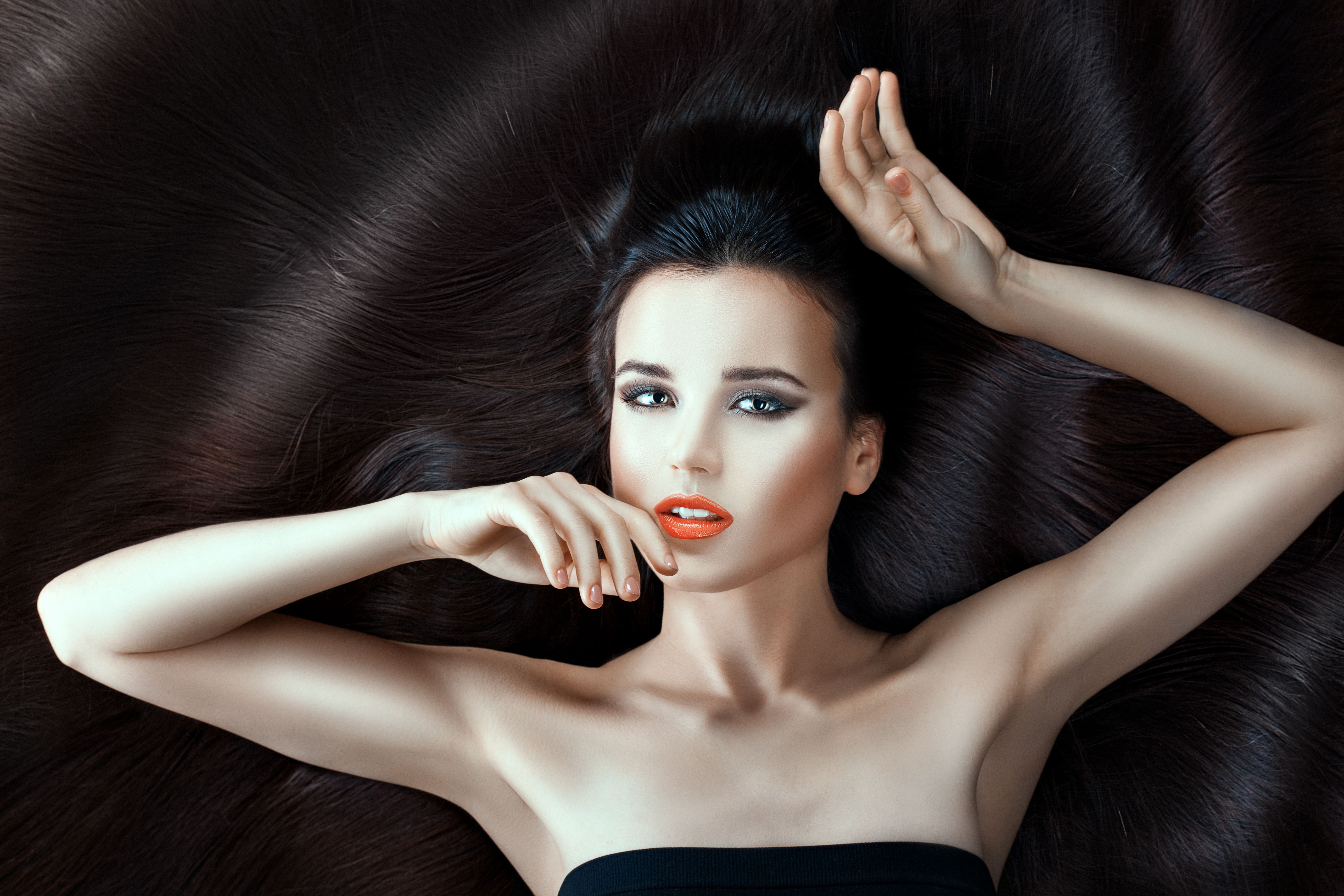 Girl lies on her long hair.