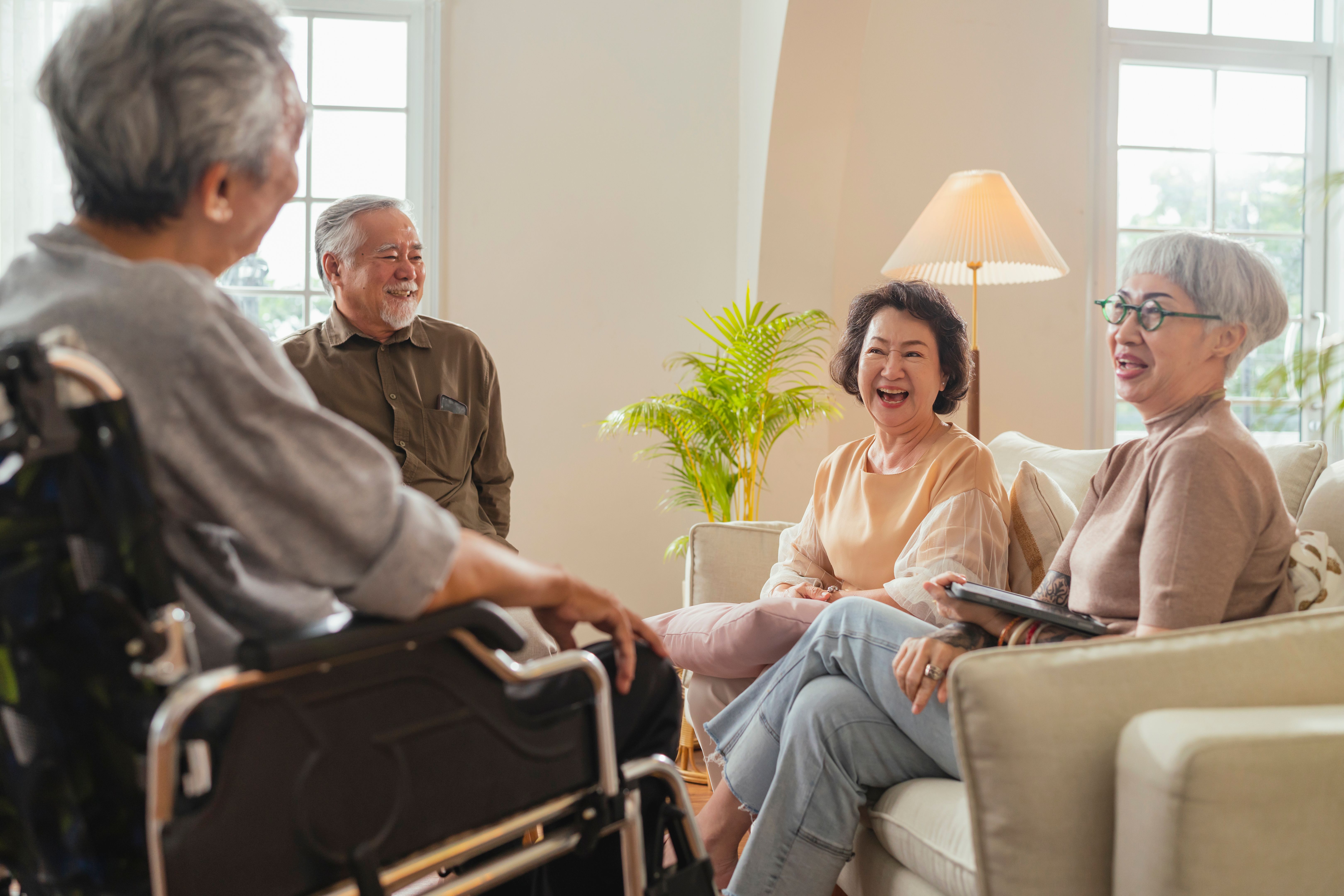 old senior asian friends retired people hapiness positive laugh smile conversation together at living room at nursing home Seniors participating in Group Activities in Adult Daycare Center