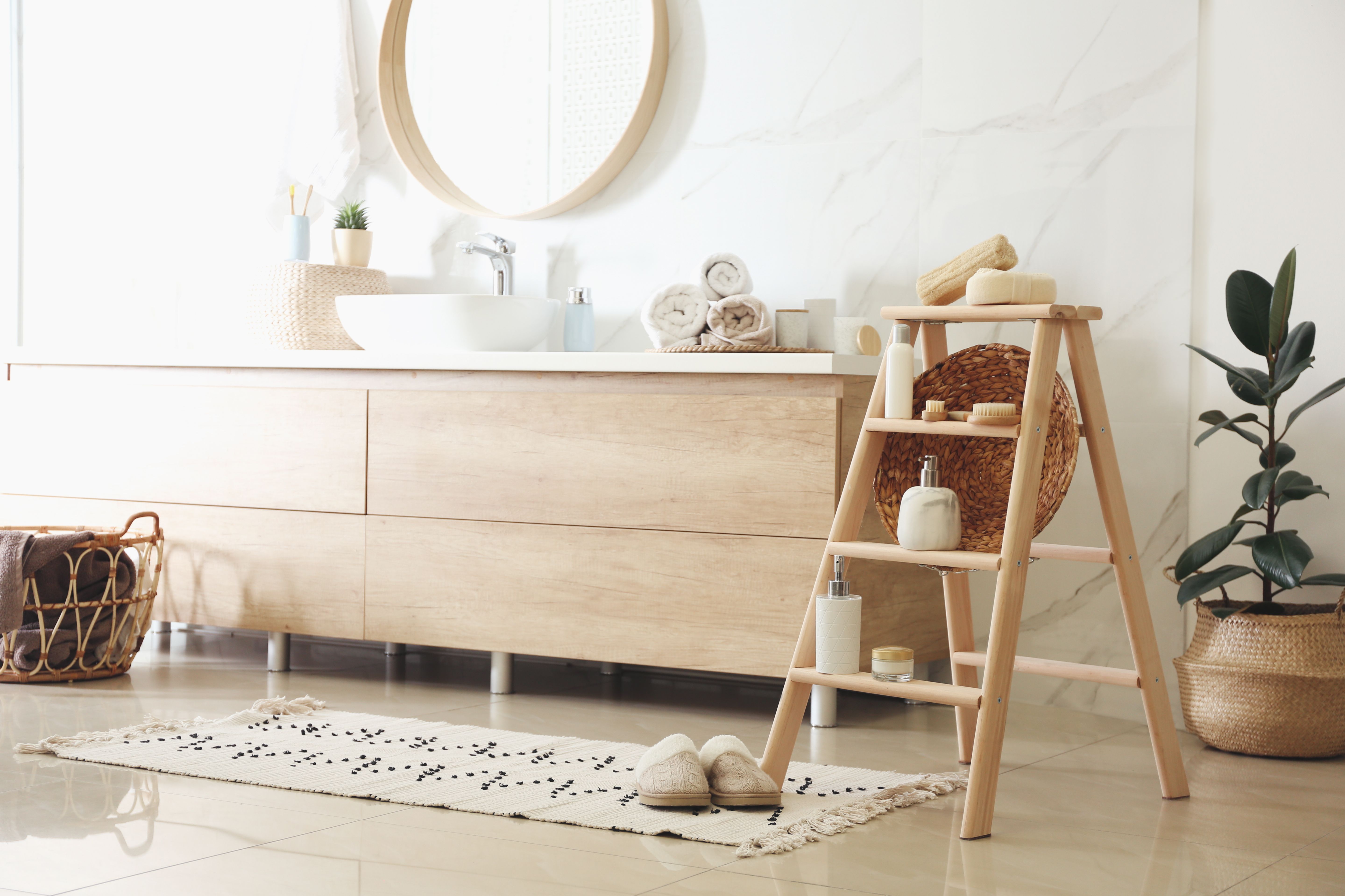 Dispensers and different toiletries on decorative ladder in bathroom. Idea for interior design