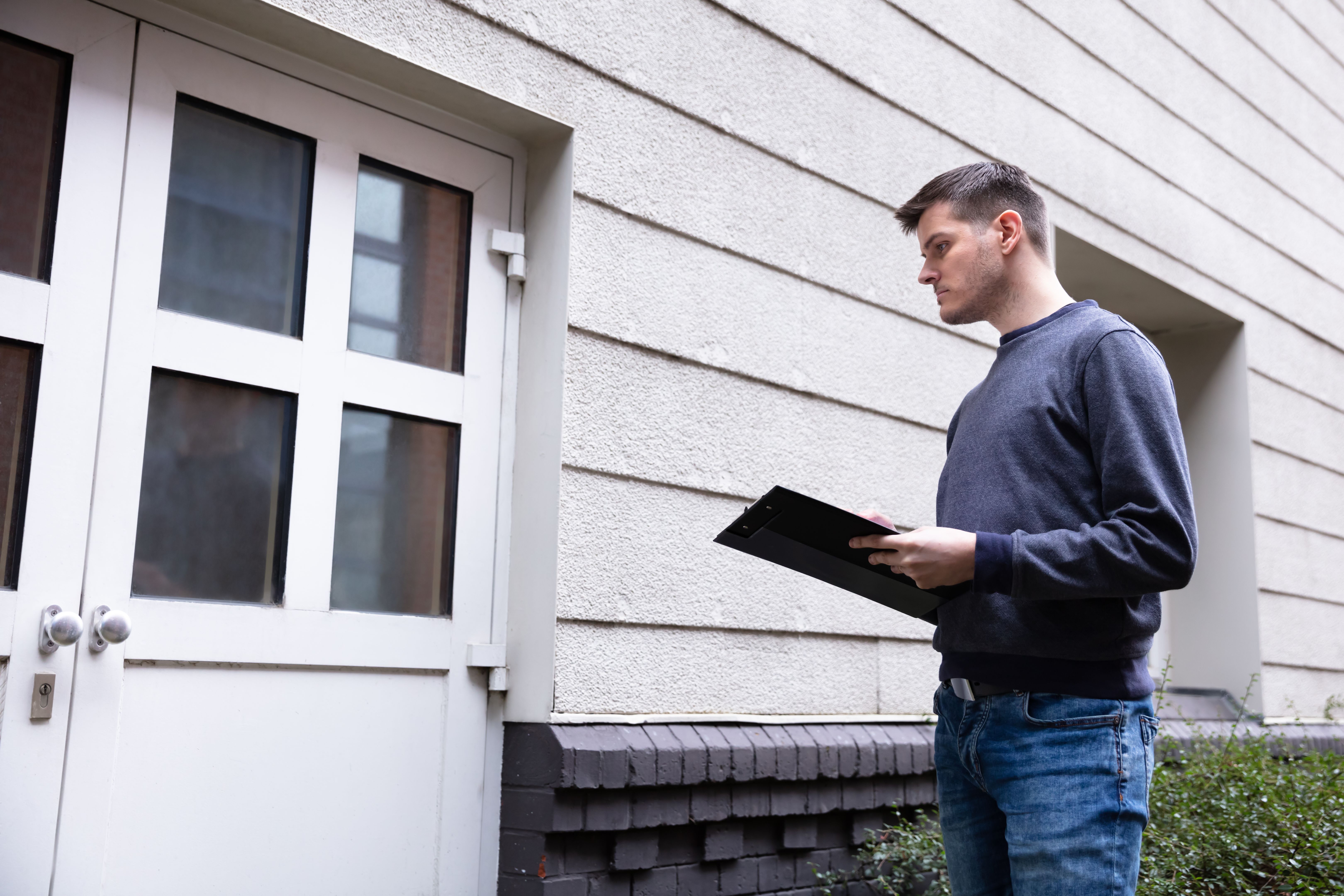 Service Man Standing In Front Of Closed Door