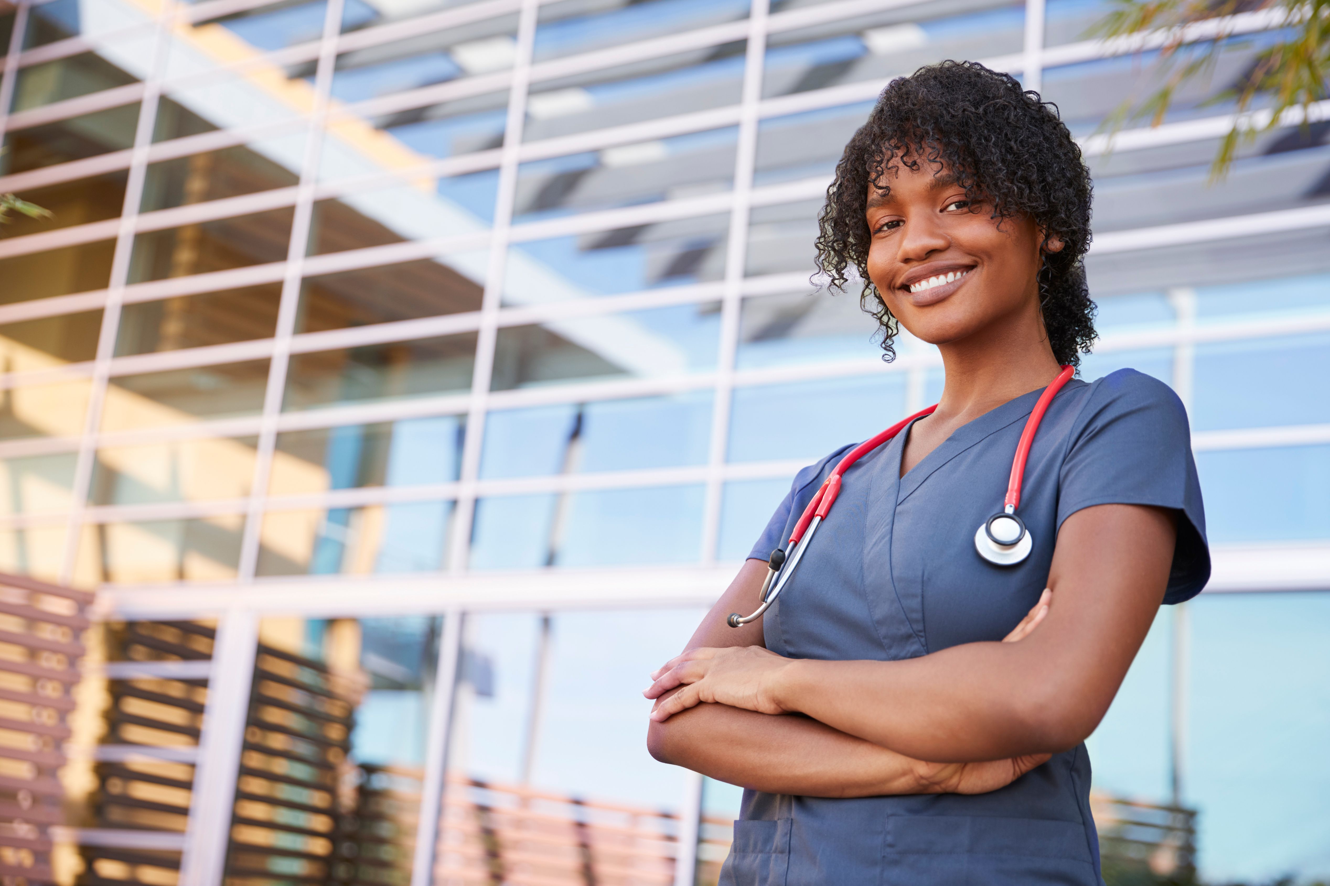 Portrait of smiling black female healthcare worker outdoors Portrait of smiling black female healthcare worker outdoors