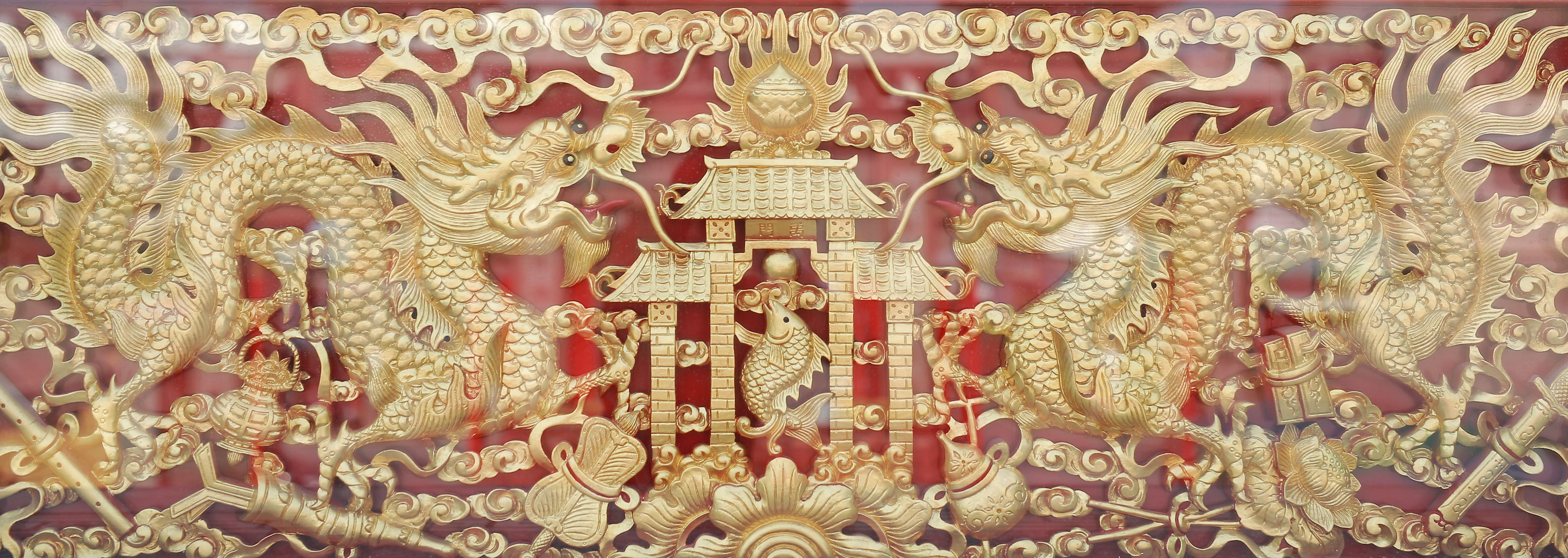 Traditional golden chinese dragon wood carved with mirror reflect.