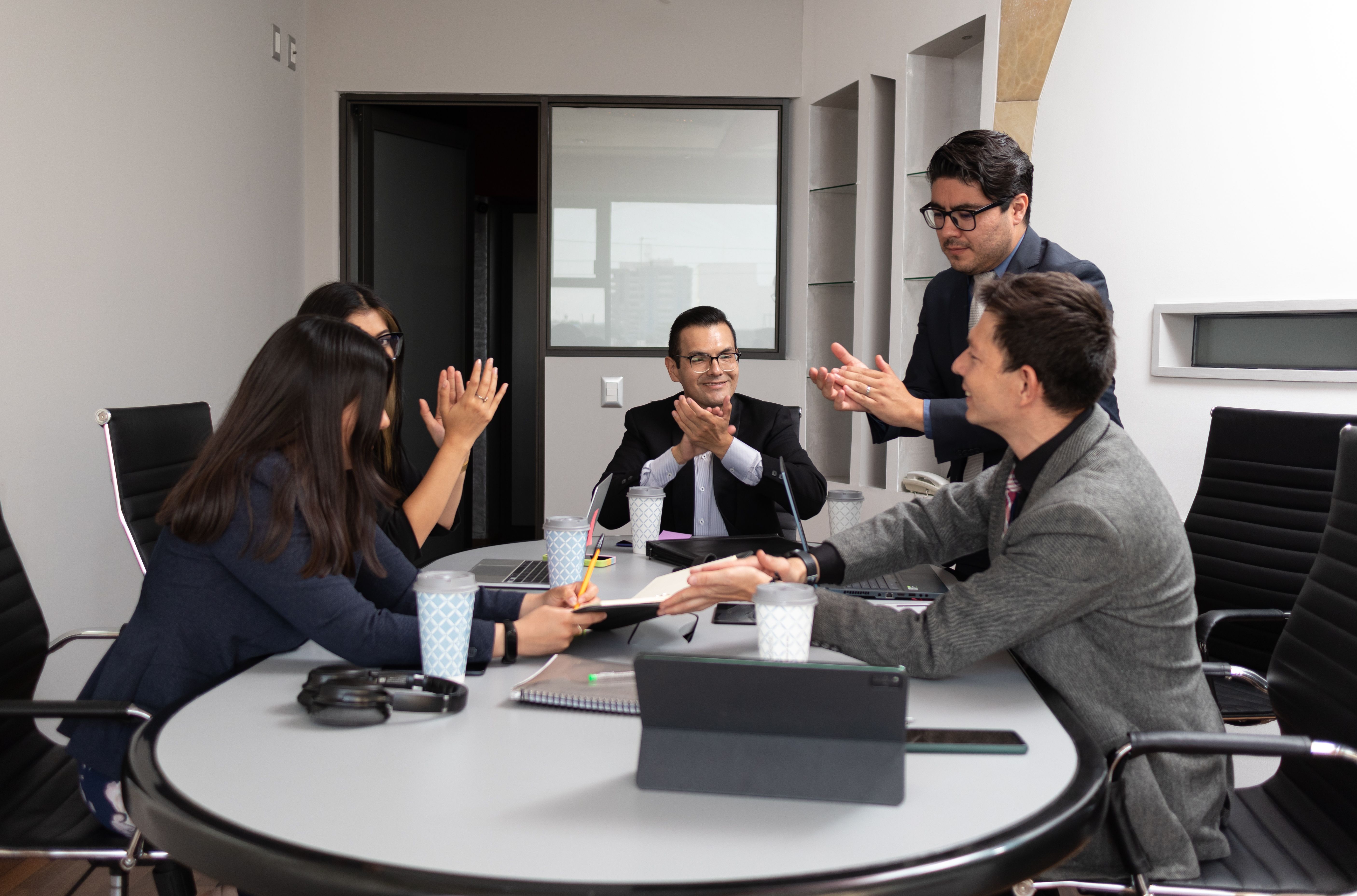 business team clapping celebrating for signing a new partnership contract at a meeting room coworking space of hispanic teamwork at the office business team clapping celebrating for signing a new partnership contract at a meeting room coworking space of hispanic teamwork at the office