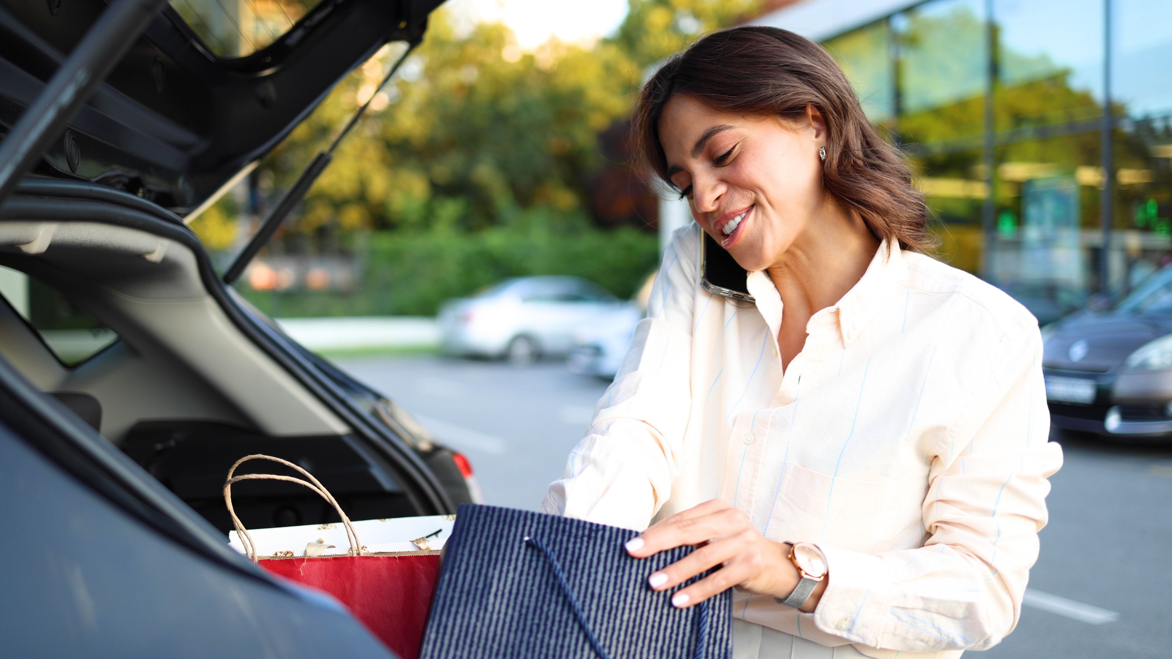 Woman chatting on the phone after shopping