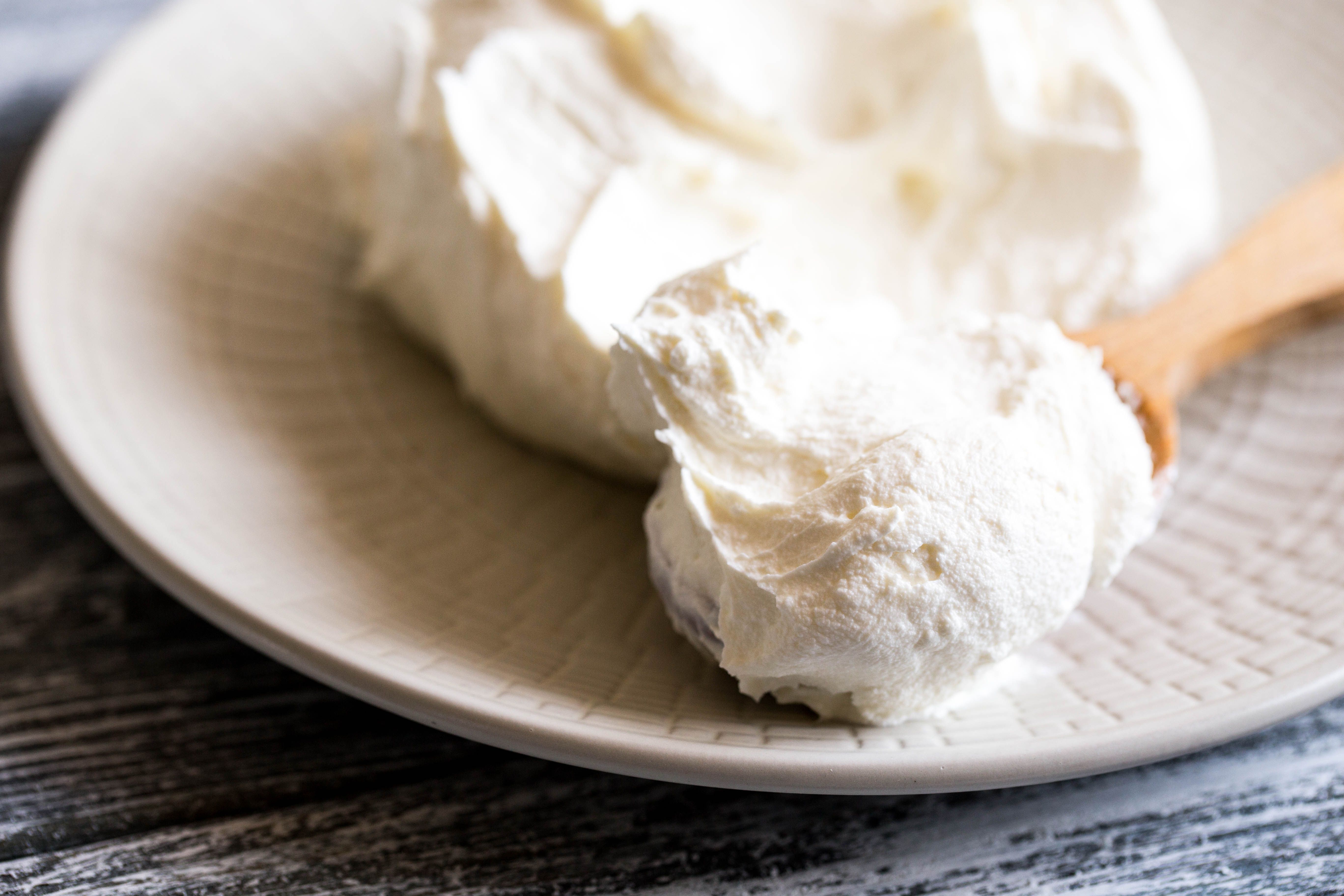 Fresh homemade mascarpone. Traditional Mascarpone cheese in wooden spoon