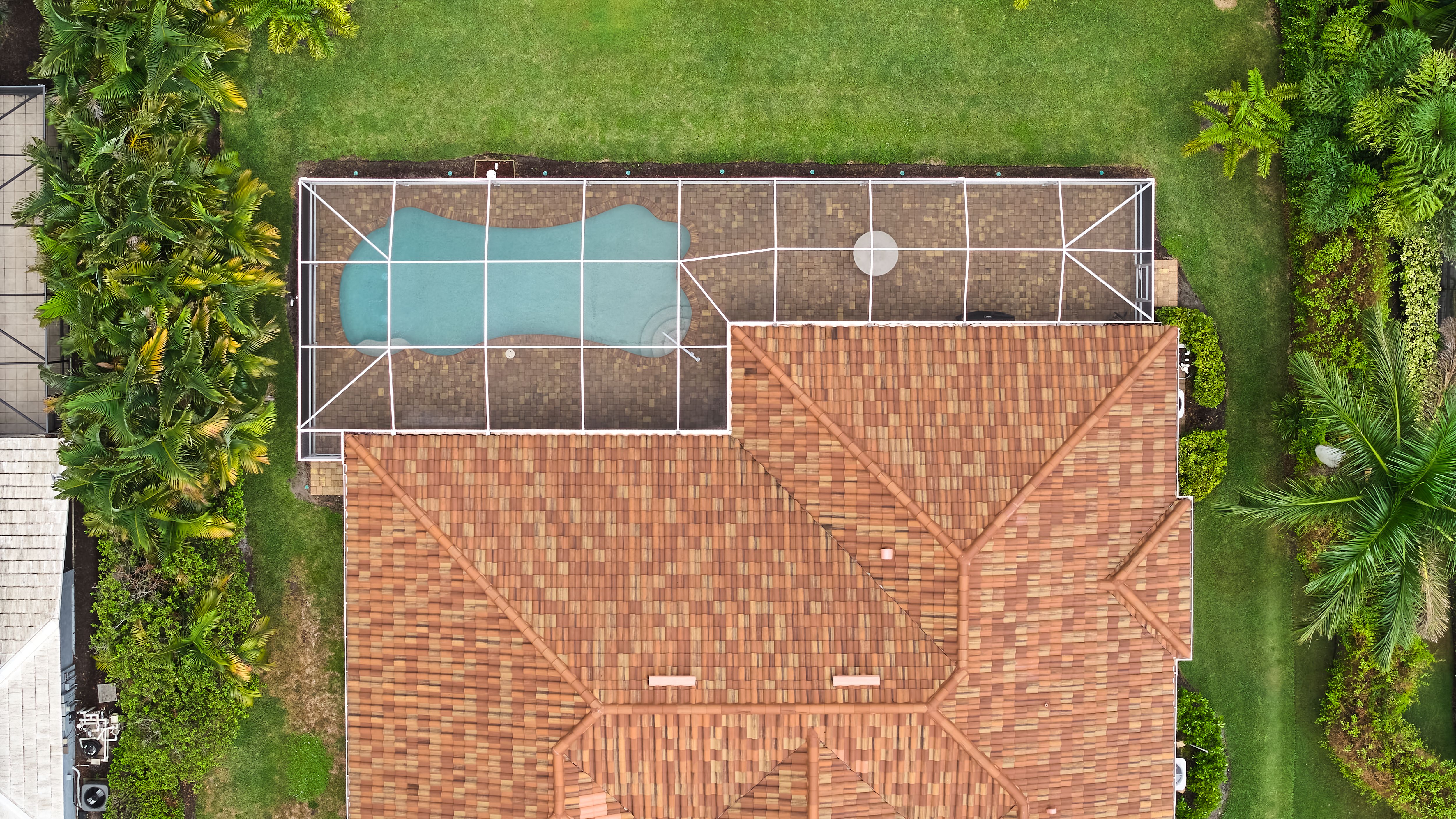 Above aerial view of screened in pool and lanai in florida house