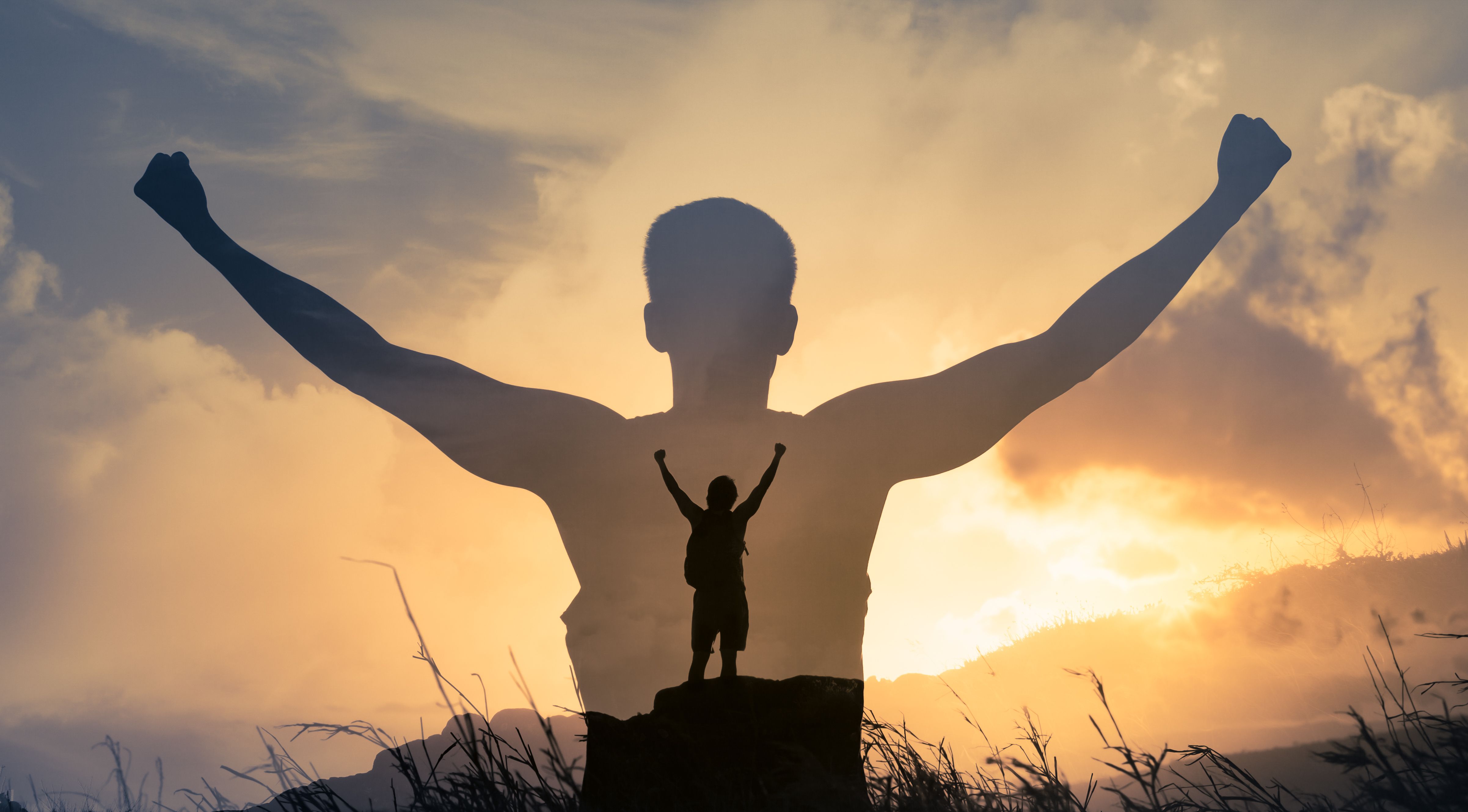 Man celebrating on top of a mountain